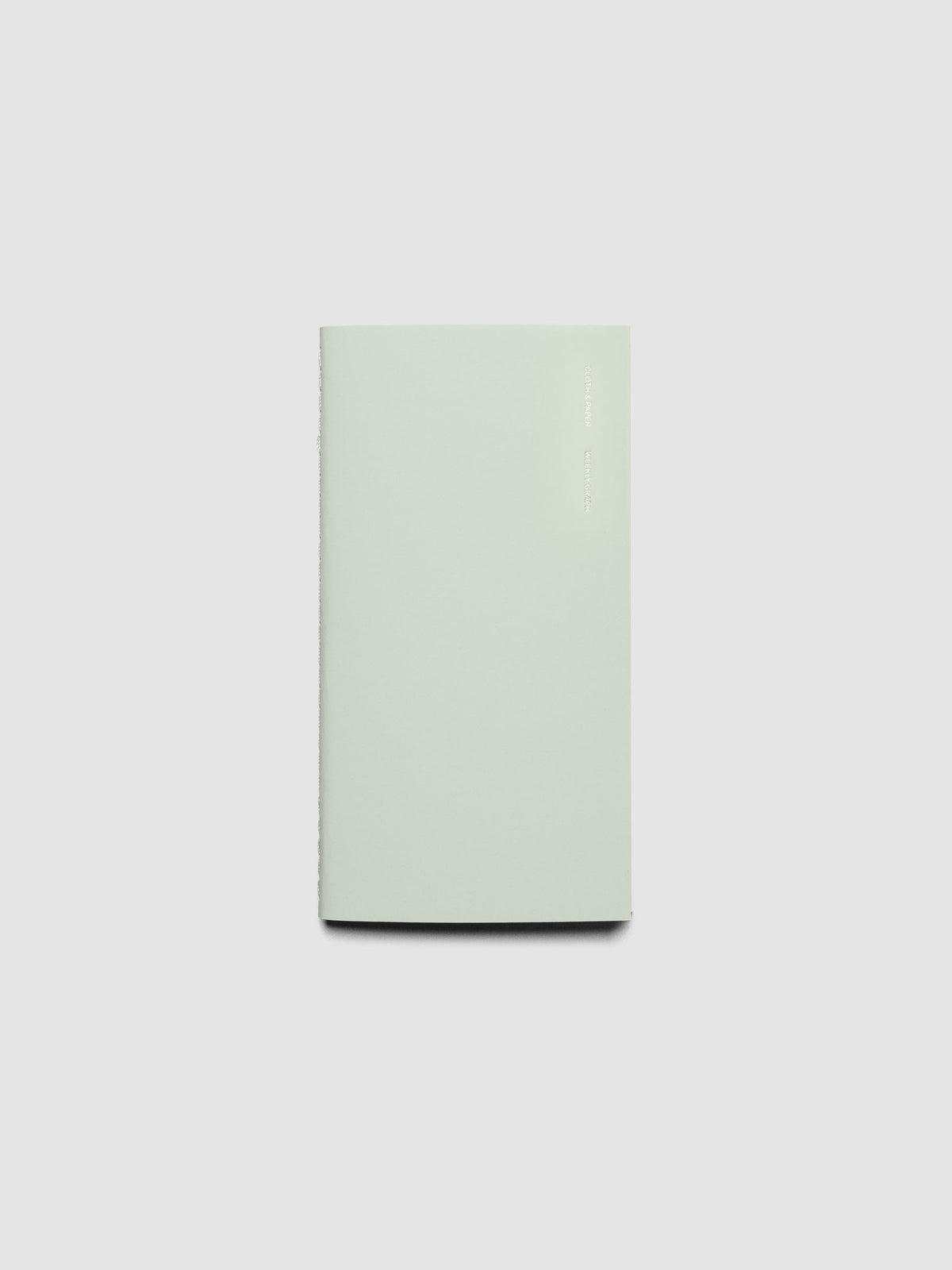 Travel Notebook, Weekly Graph Style, Matcha. Notebook displayed closed on a neutral background.