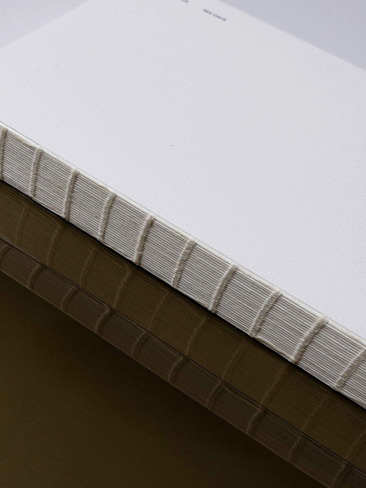 A5 notebook displayed on a neutral background, showing its exposed spine.