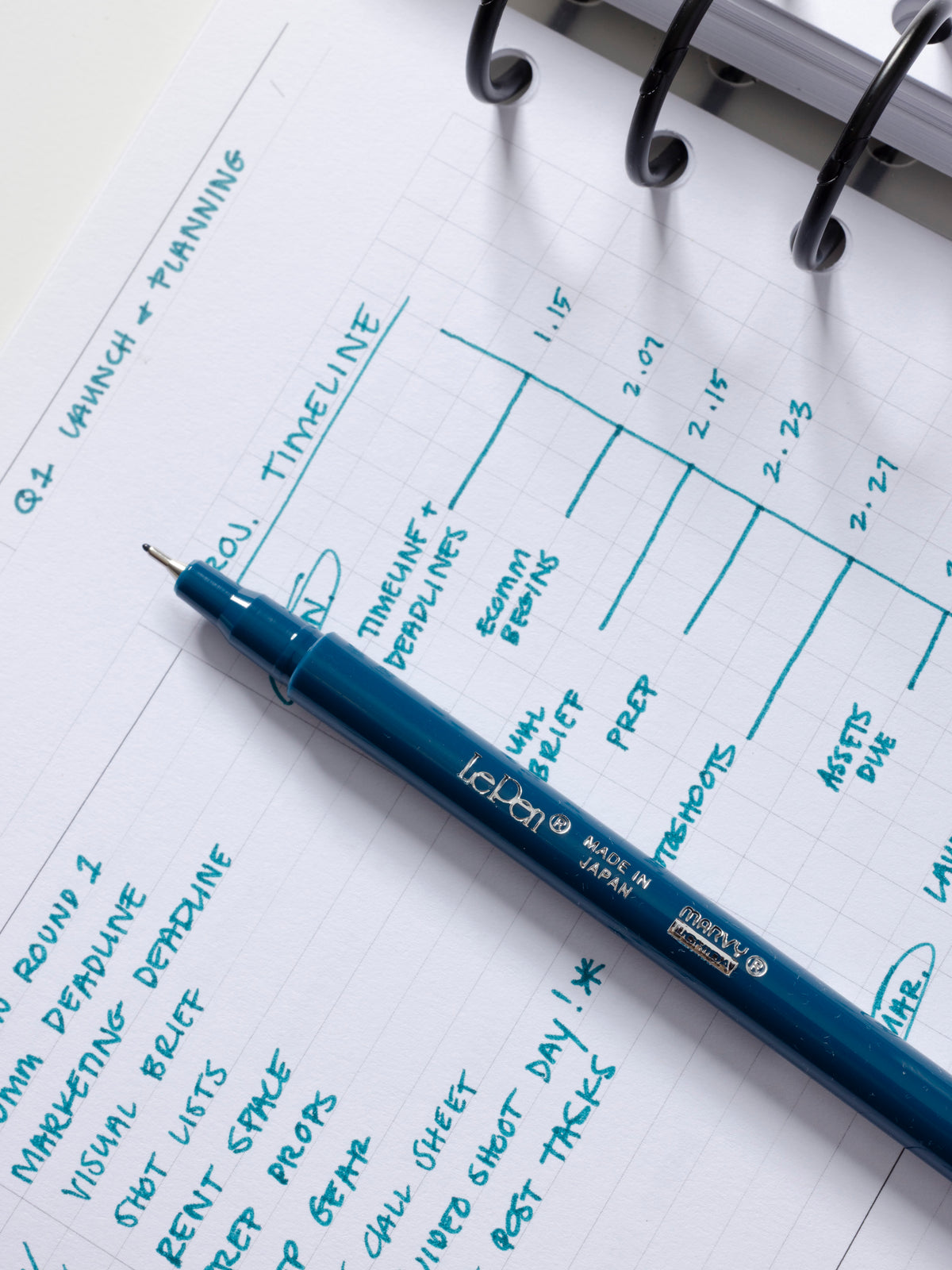 Le Pen by Marvy Uchida in Oriental Blue shown on a planner insert with a writing sample.