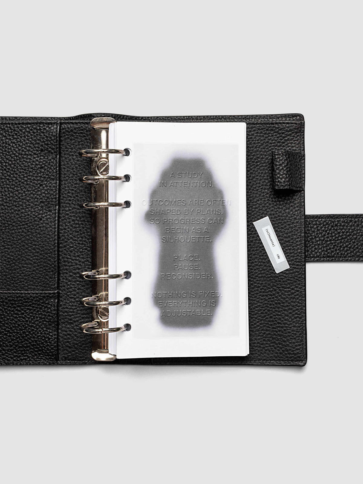 Silhouette Planner Dashboard in Personal. Greyscale silhouette print with embossed text on paper. Image 2 of 2.
