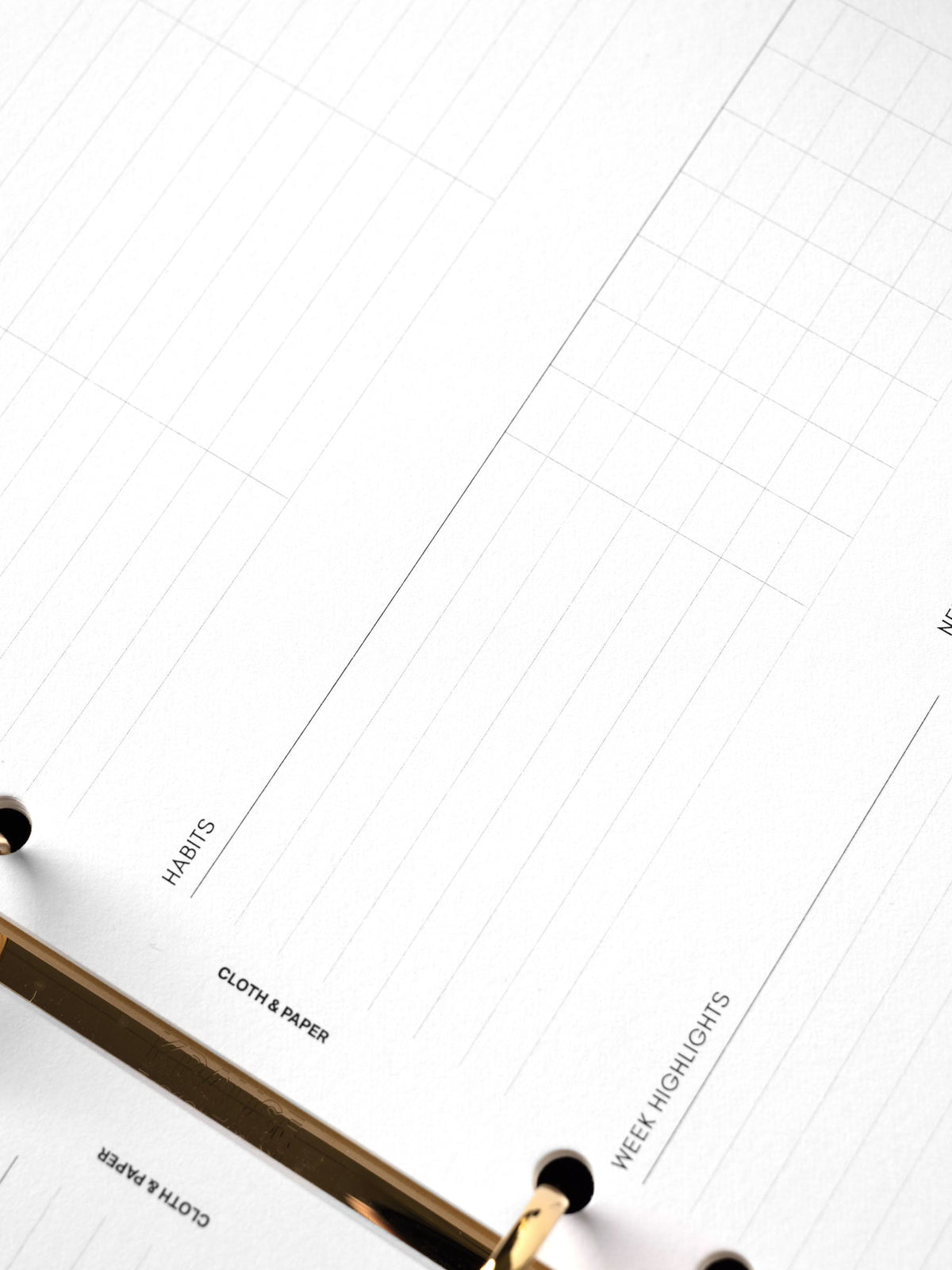 Weekly Essentials Planner Inserts, A5 6-Ring Punch, angled close-up of the Habits section and the small ruled tracking grid