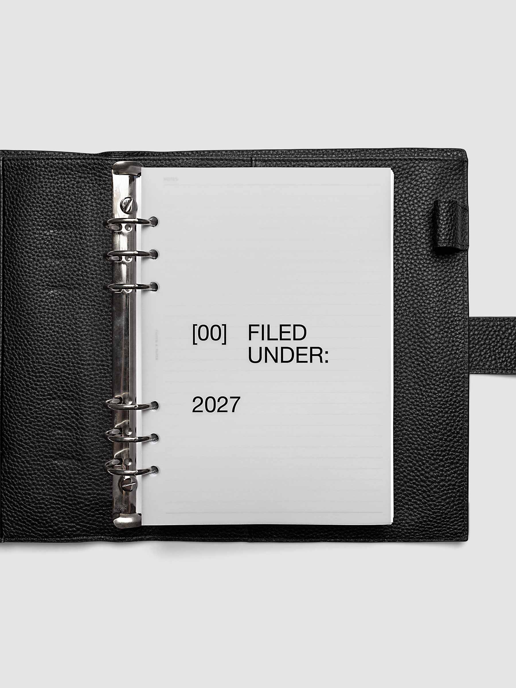 2027 Front + Monthly Dashboard Overlays, Avant Garde, A5 6-Ring Punch, vellum dashboard overlay shown layered inside a planner