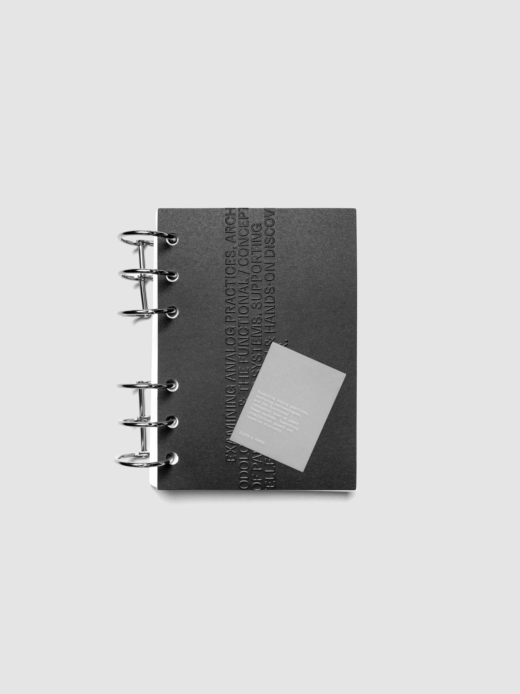 Black embossed Analog Embossed Planner Dashboard with drop card shown in size A6.