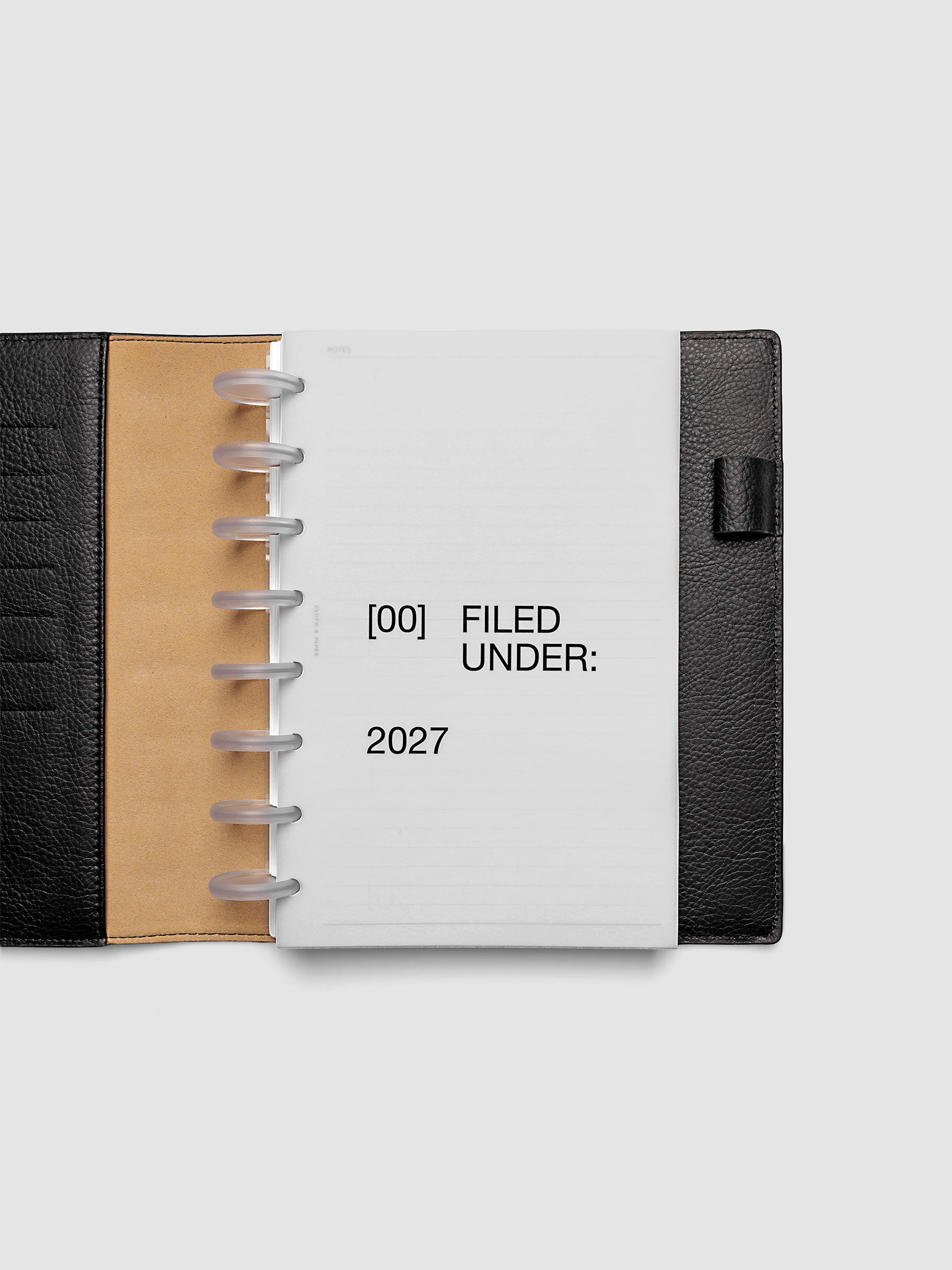 2027 Front + Monthly Dashboard Overlays, Avant Garde, Half Letter 8-Disc Punch, vellum dashboard overlay shown layered inside a planner