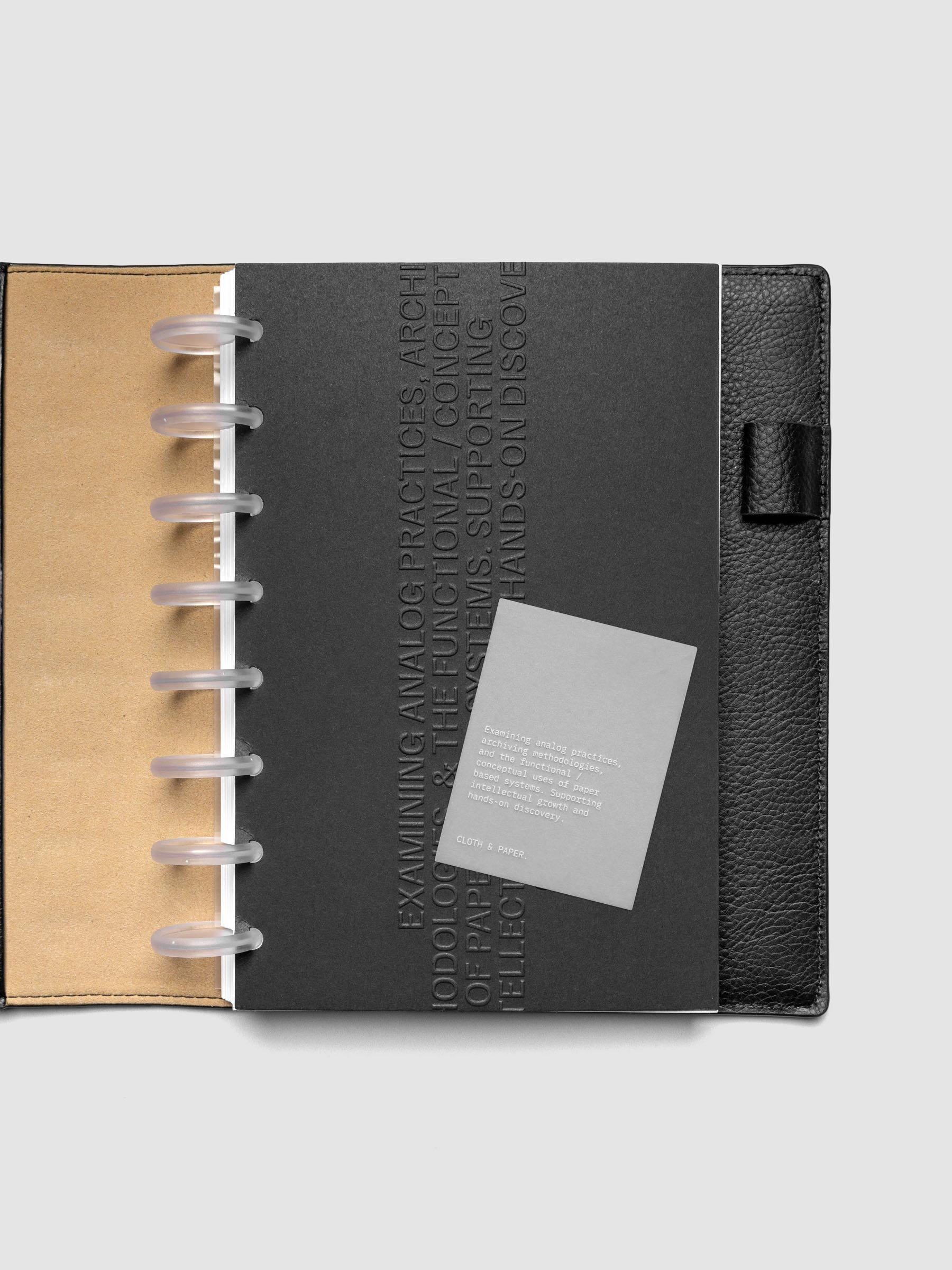 Black embossed Analog Embossed Planner Dashboard with drop card shown in size Half Letter 8-Disc Punch.