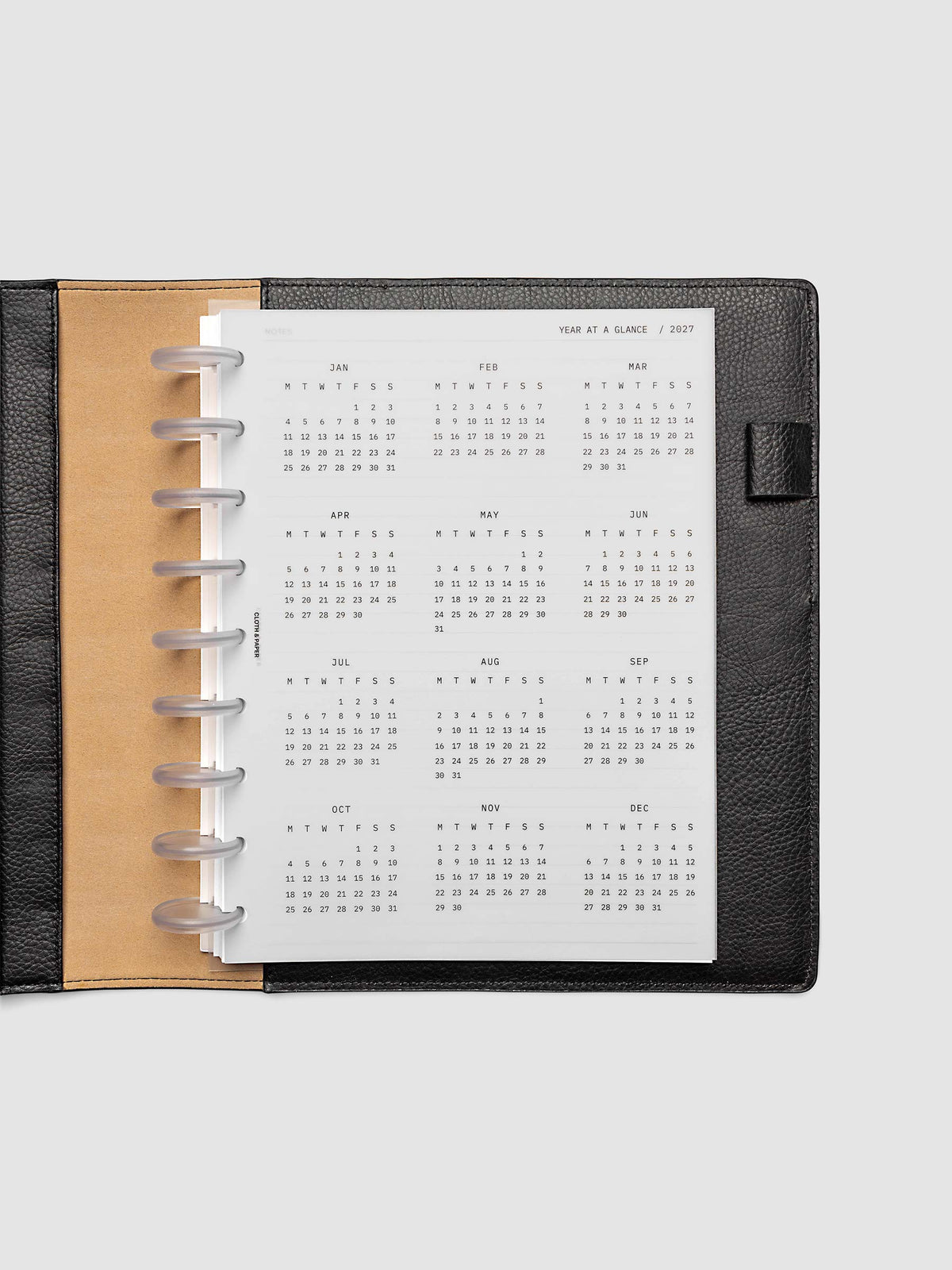 2027 Year At A Glance Dashboard Monday Start, HP Classic 9-Disc Punch, translucent vellum year-at-a-glance calendar shown inside a planner