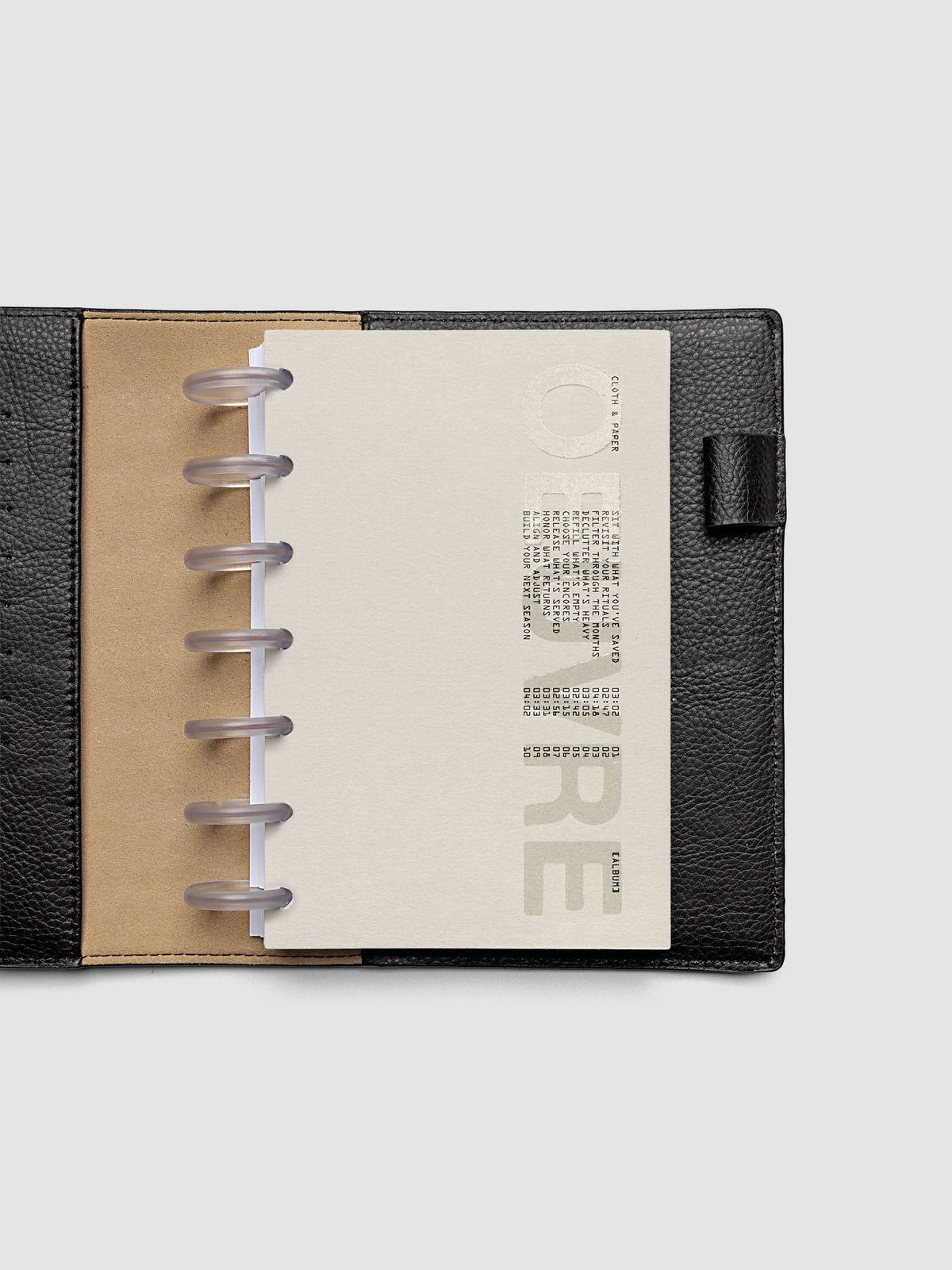 Oeuvre Planner Dashboard in HP Mini 7-Disc Punch size shown in a planner