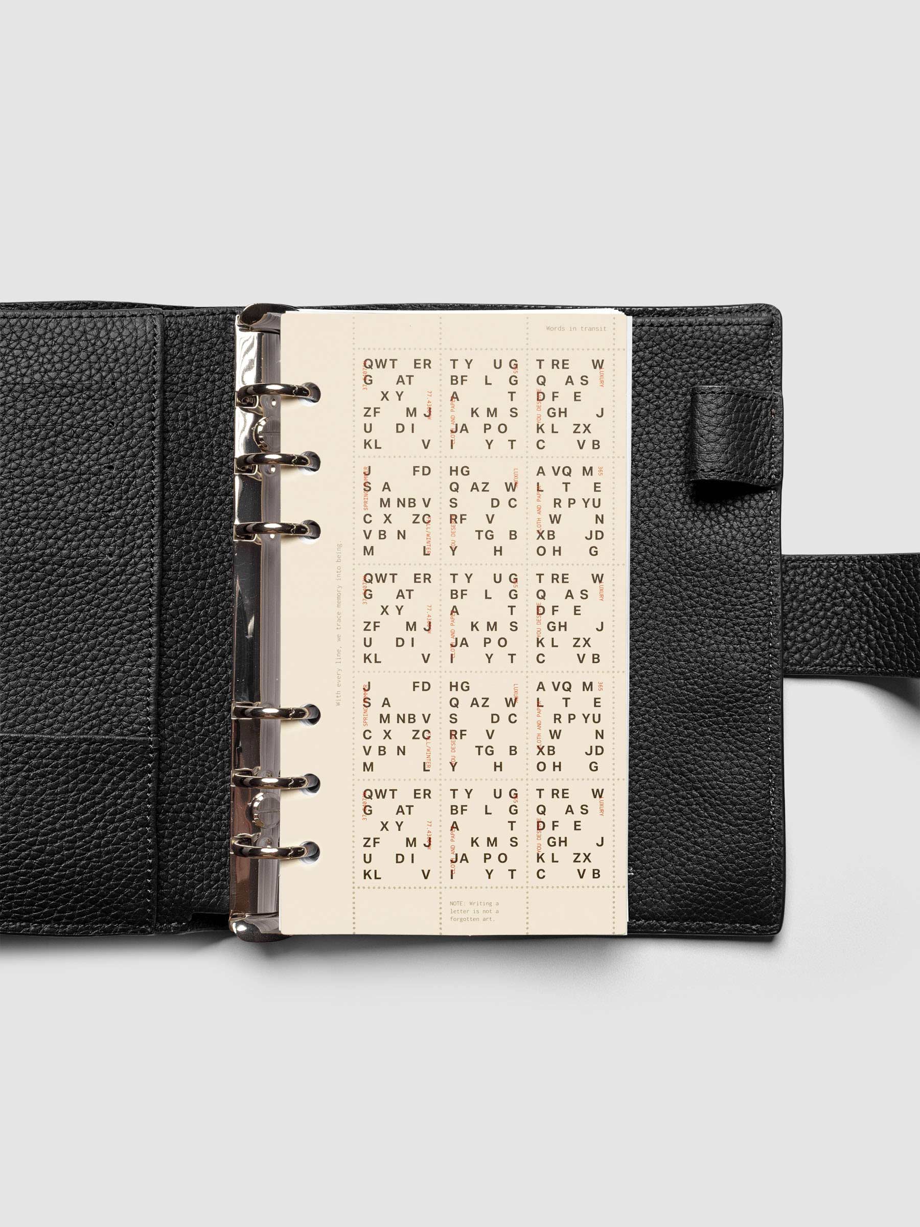 Stamp Sheet Planner Dashboard shown in a Personal black leather agenda.