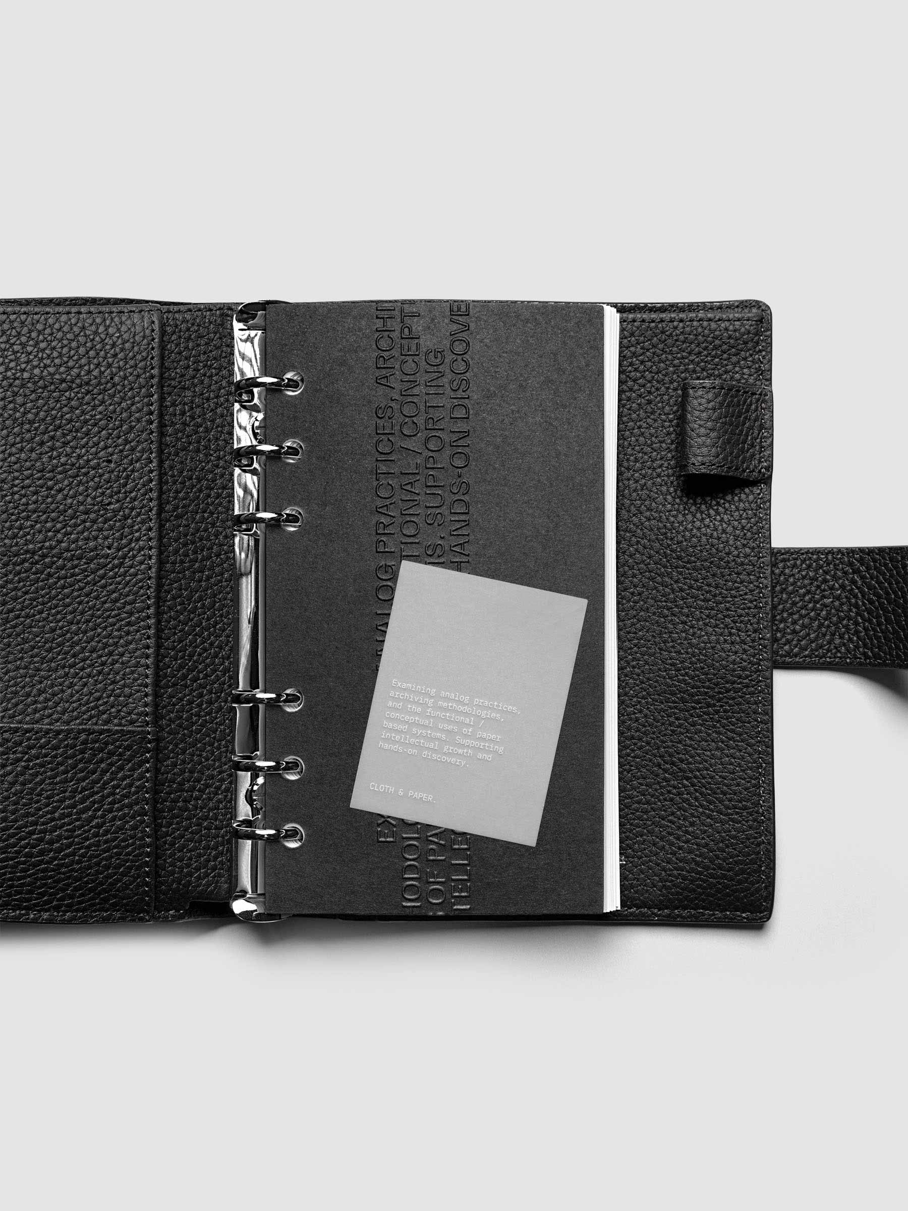Black embossed Analog Embossed Planner Dashboard with drop card shown in size Personal.