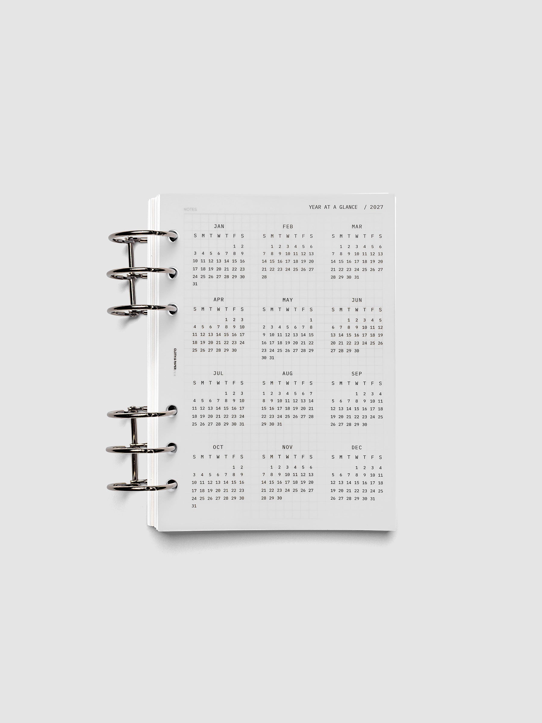 2027 Year At A Glance Dashboard Sunday Start, Personal Wide 6-Ring Punch, translucent vellum year-at-a-glance calendar shown inside a planner