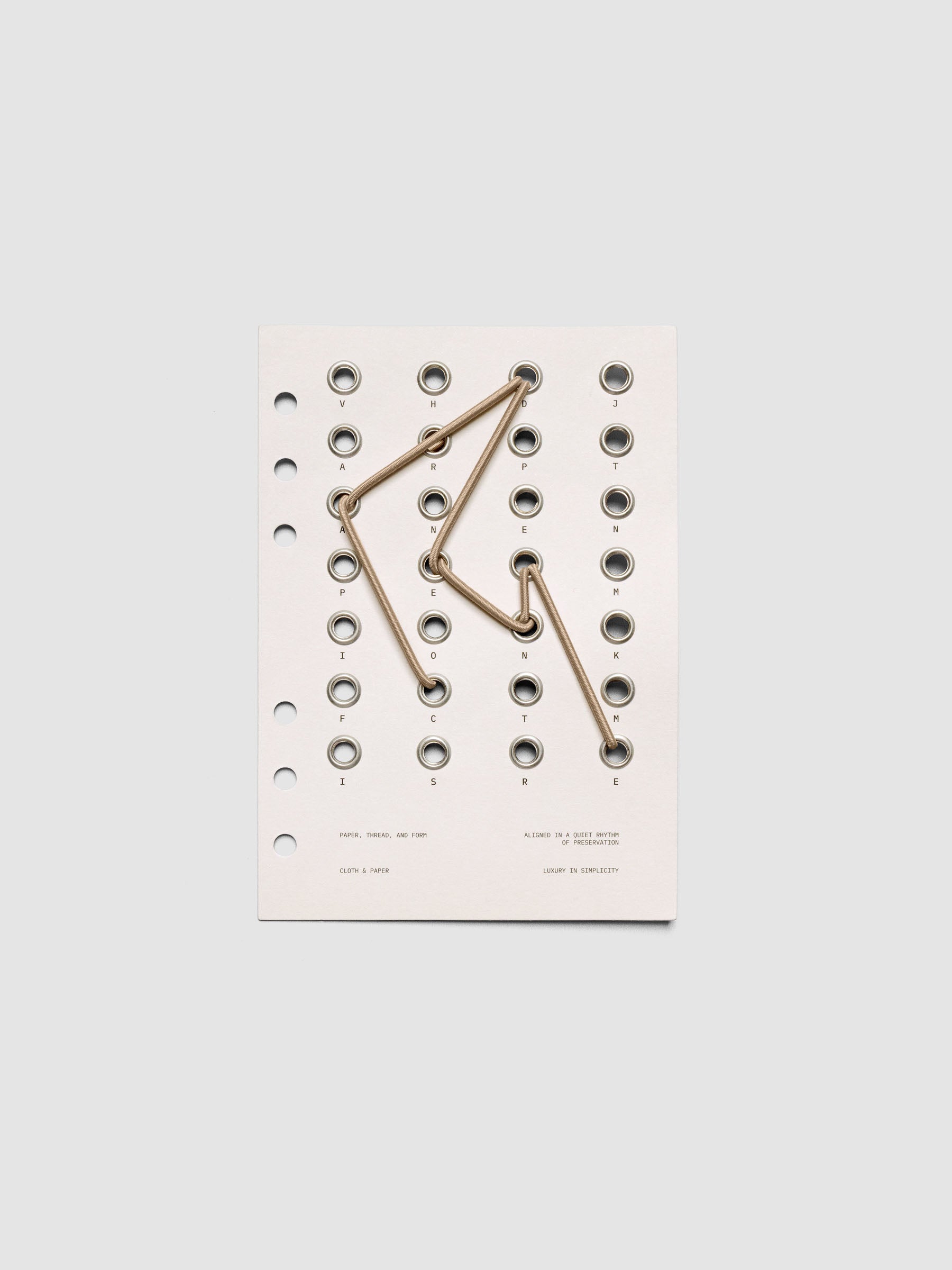 Cadence Dashboard with grommets and string on beige cardstock shown in size Personal Wide for 6-ring planners and notebooks.
