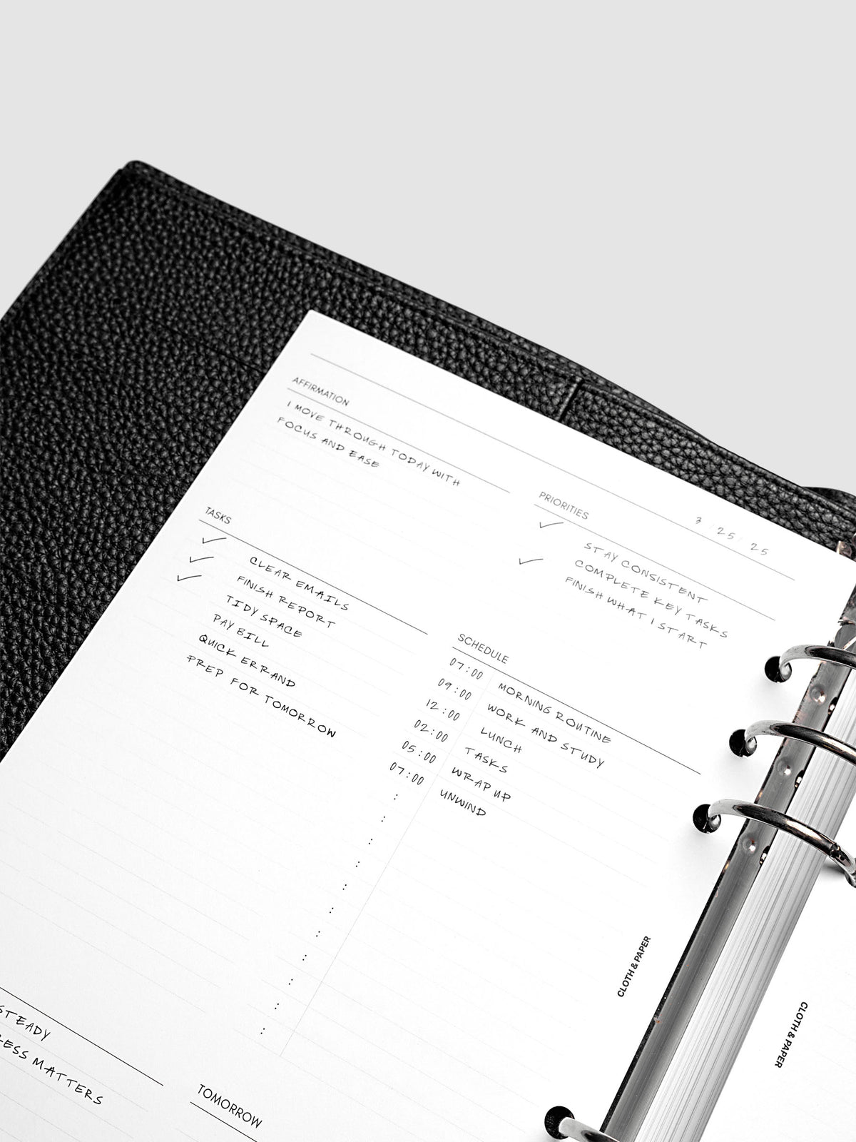 Close up of the demo page for the Daily Essentials Planner insert inside an A5 black agenda.