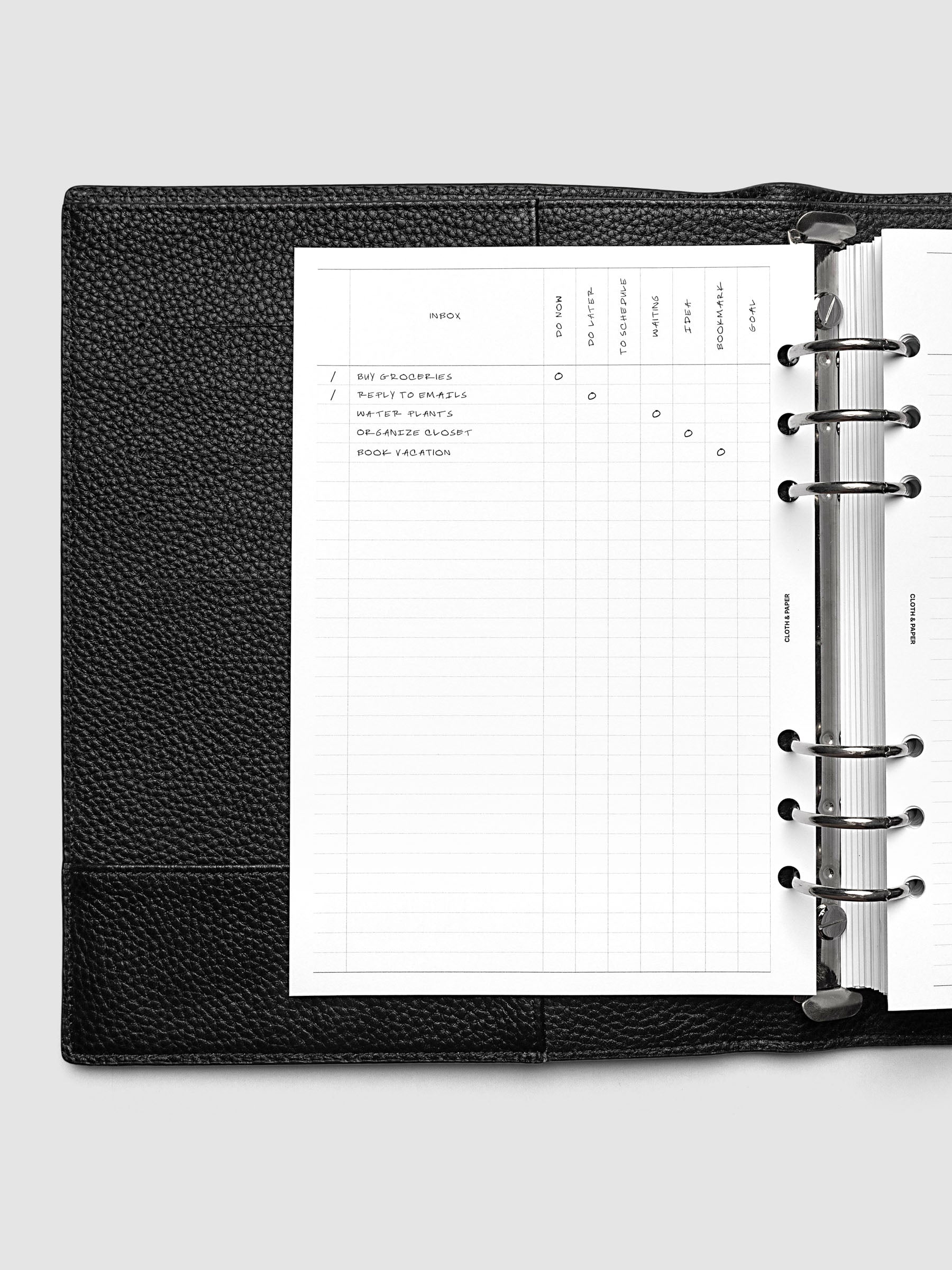 Demo page of the Inbox Sorting Planner Inserts shown pre-punched for 6-Ring A5 planners in a black agenda.