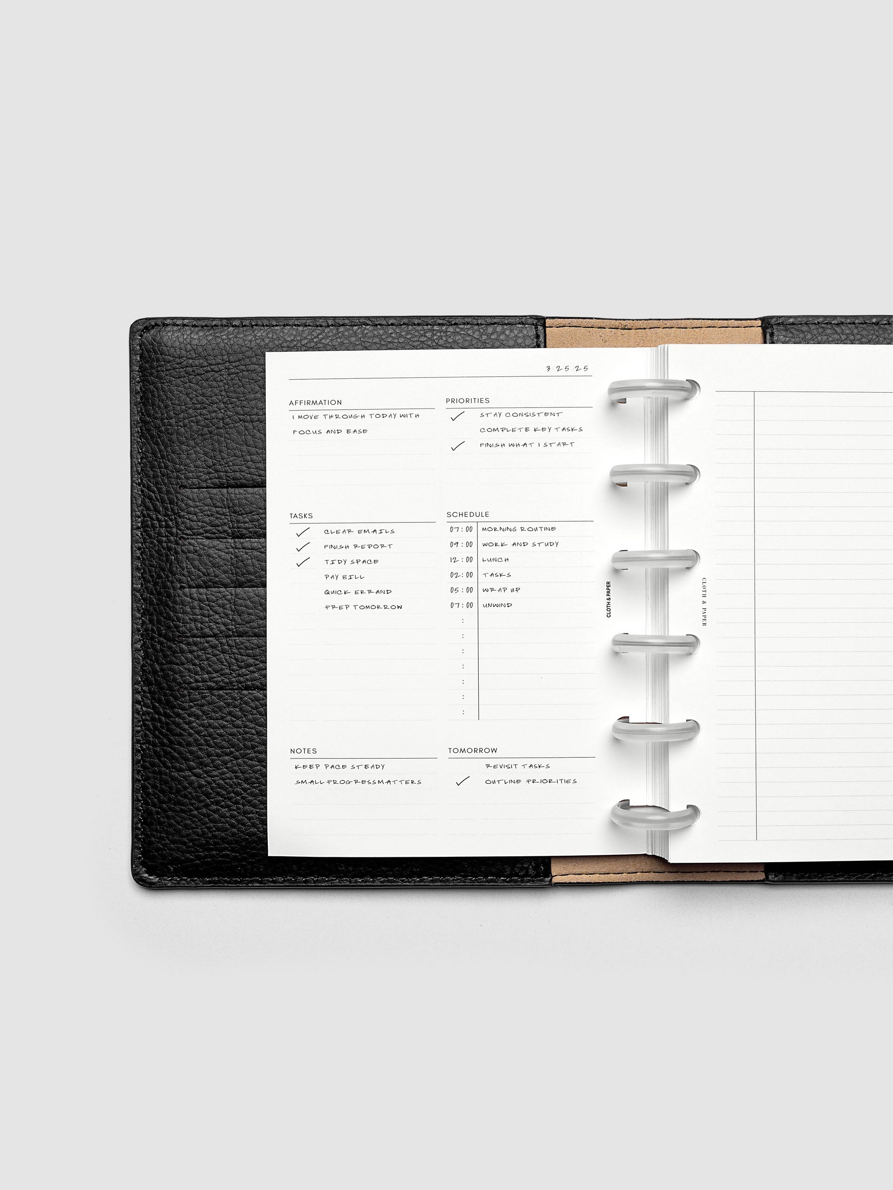 Demo page for the Daily Essentials Planner Inserts shown in size CP Petite inside a black folio.