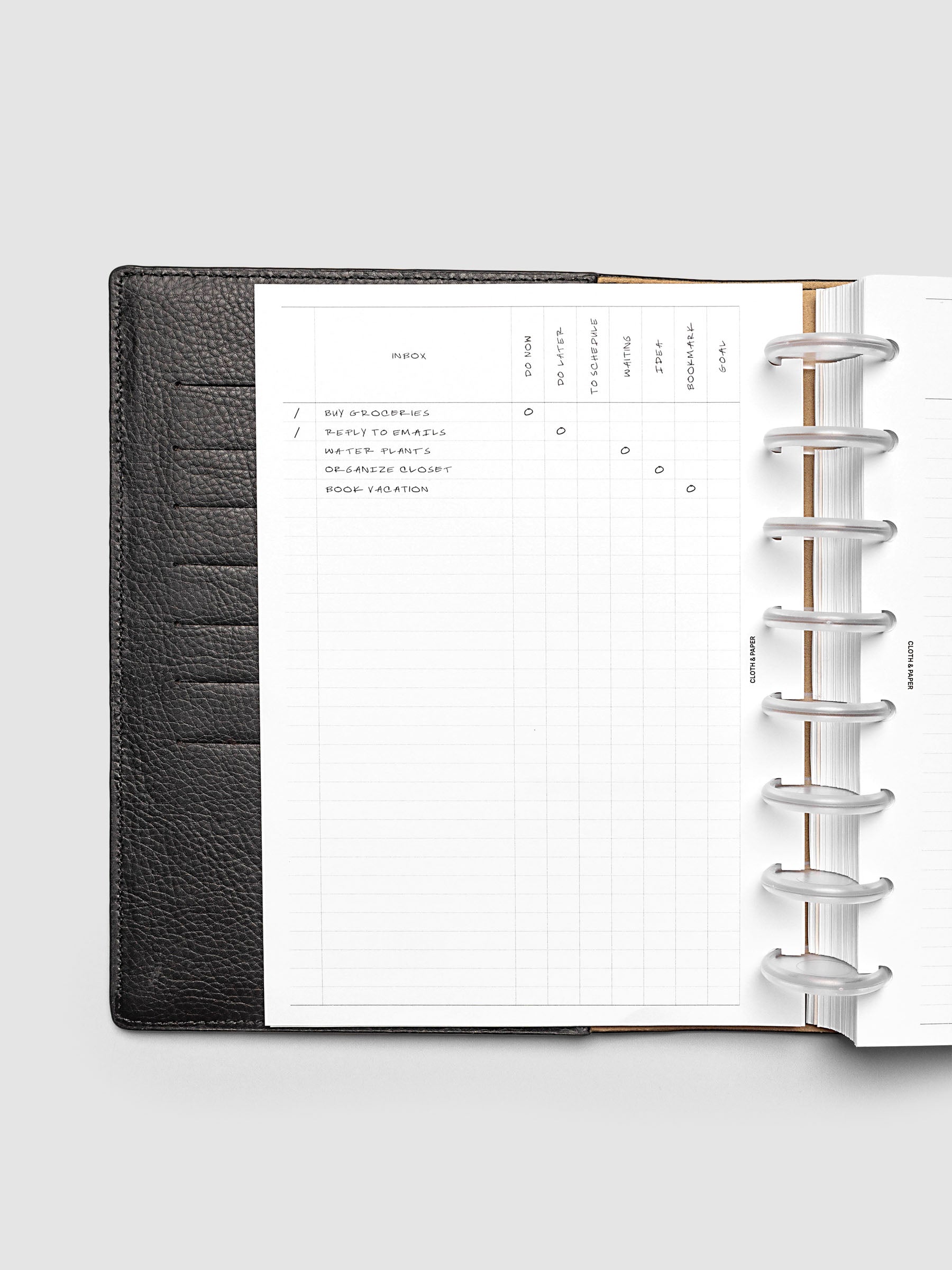 Demo page for Inbox Sorting Planner Inserts shown pre-punched for discbound Half Letter planners in a black folio.