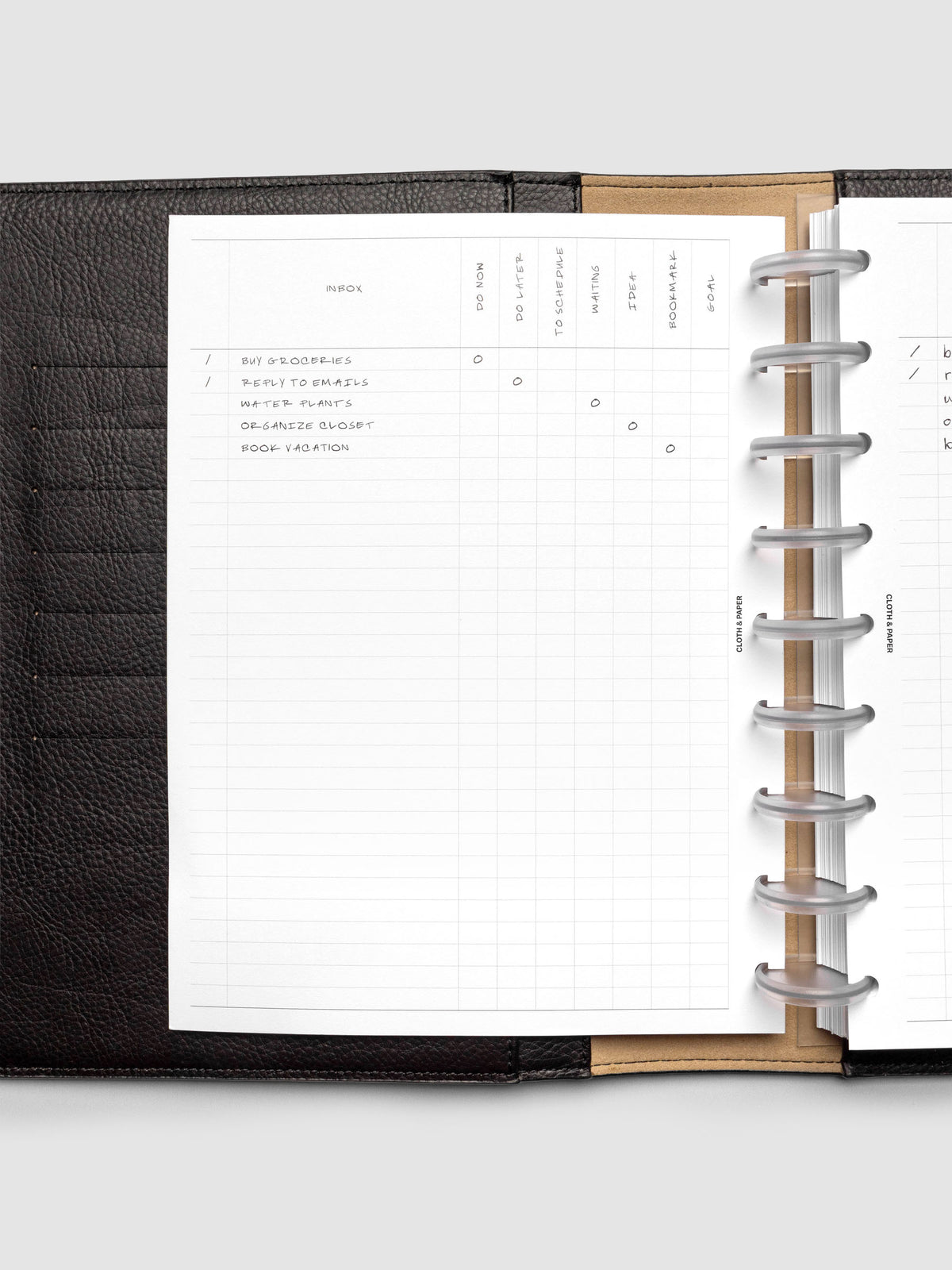 Demo page for Inbox Sorting Planner Inserts shown pre-punched for discbound HP Classic planners in a black folio.