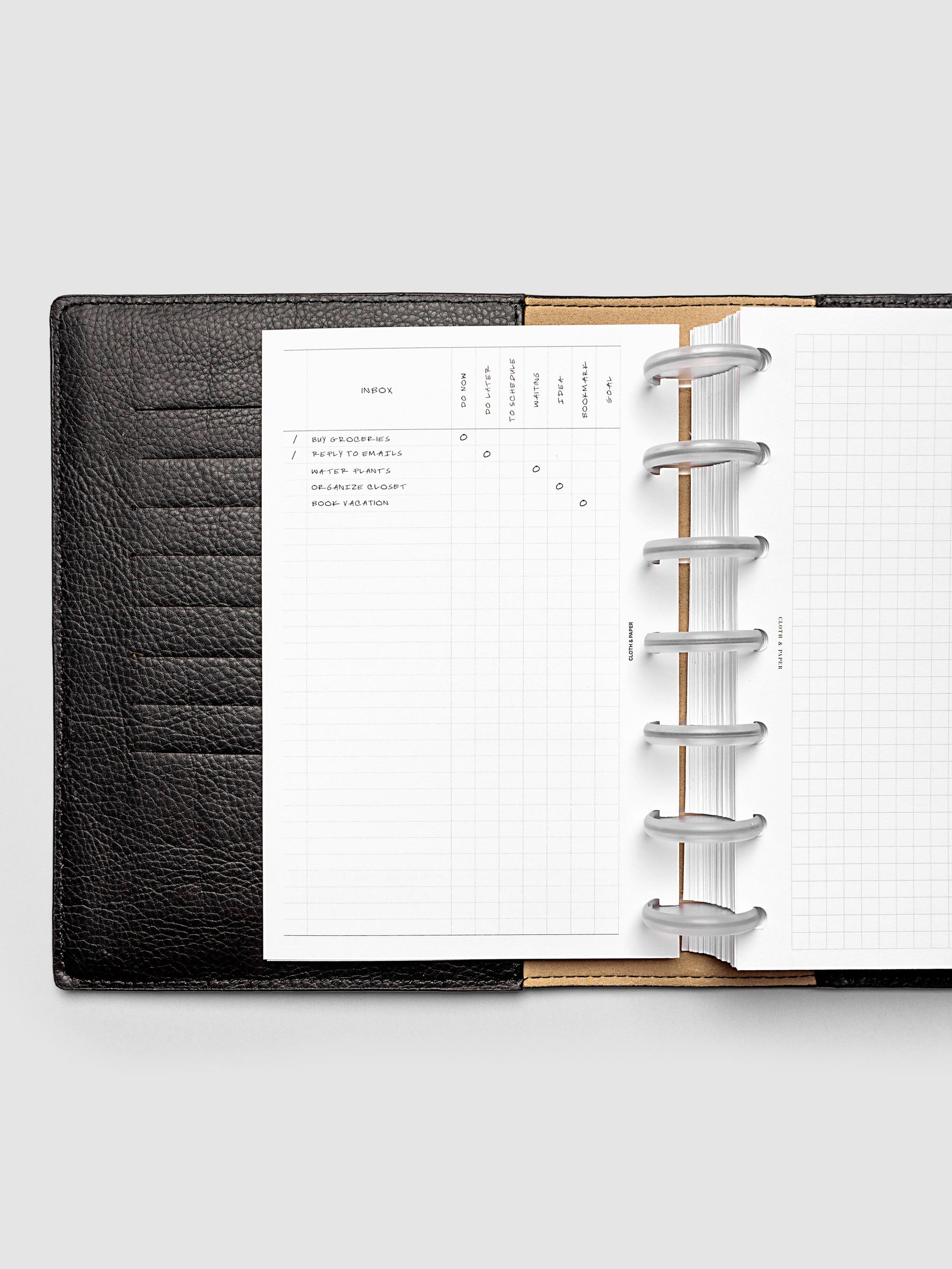 Demo page for Inbox Sorting Planner Inserts shown pre-punched for discbound HP Mini planners in a black folio.