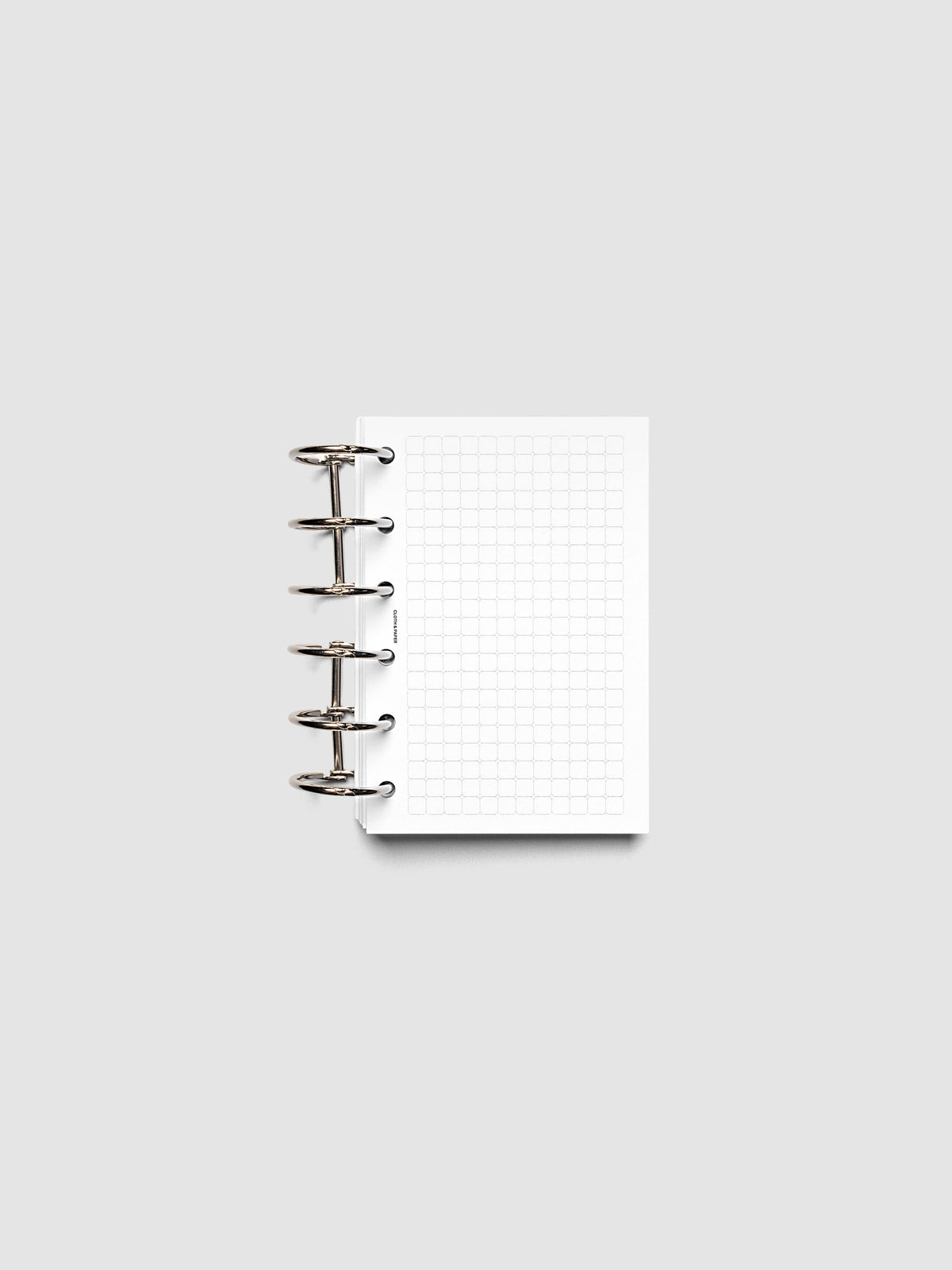Rounded Graph Planner Insert Pocket 6-Ring Punch open to an unused grid page