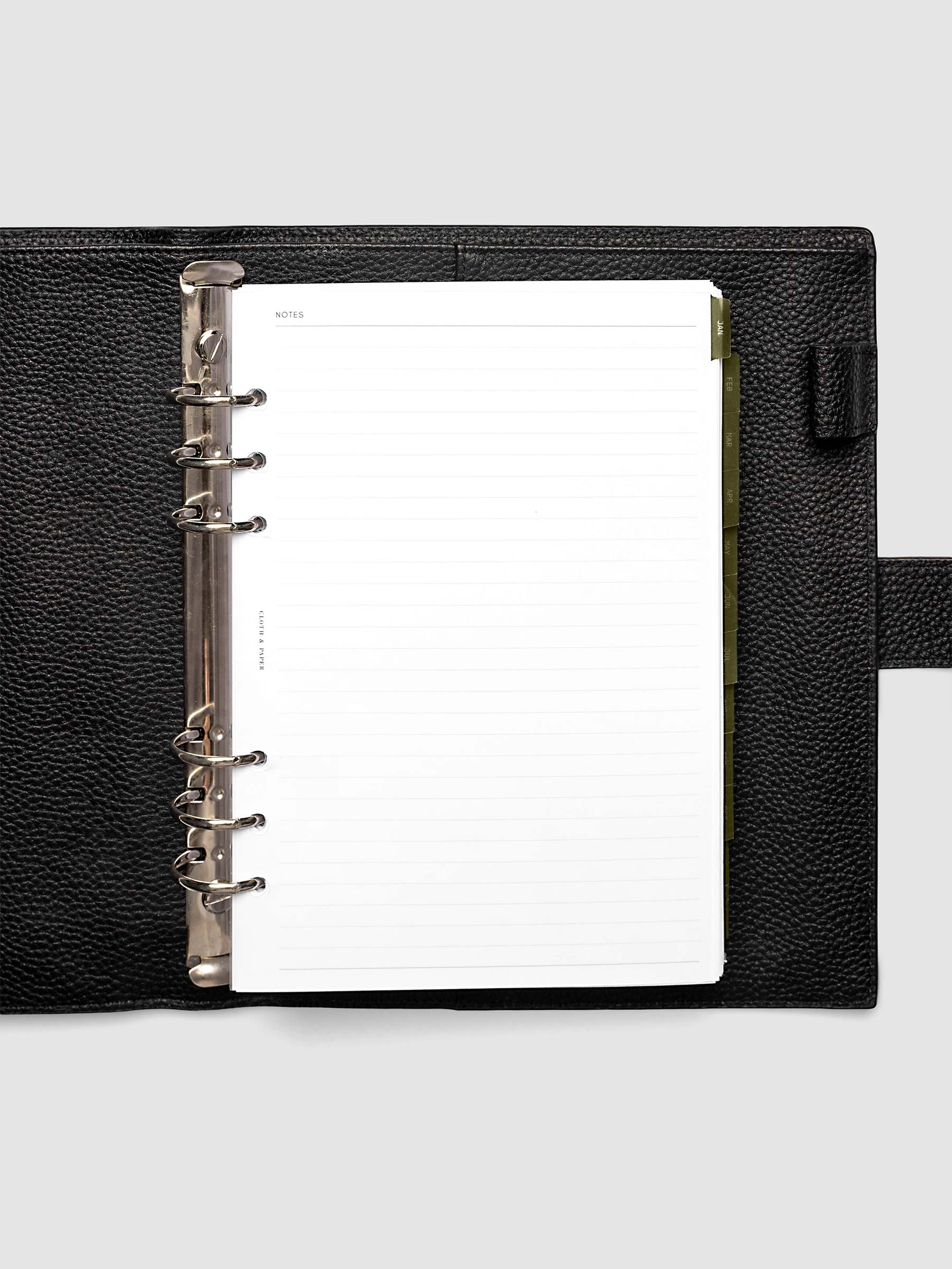 A5 6-Ring Punch Ultra-Thin Monthly Dividers in olive green shown tabbed inside a planner