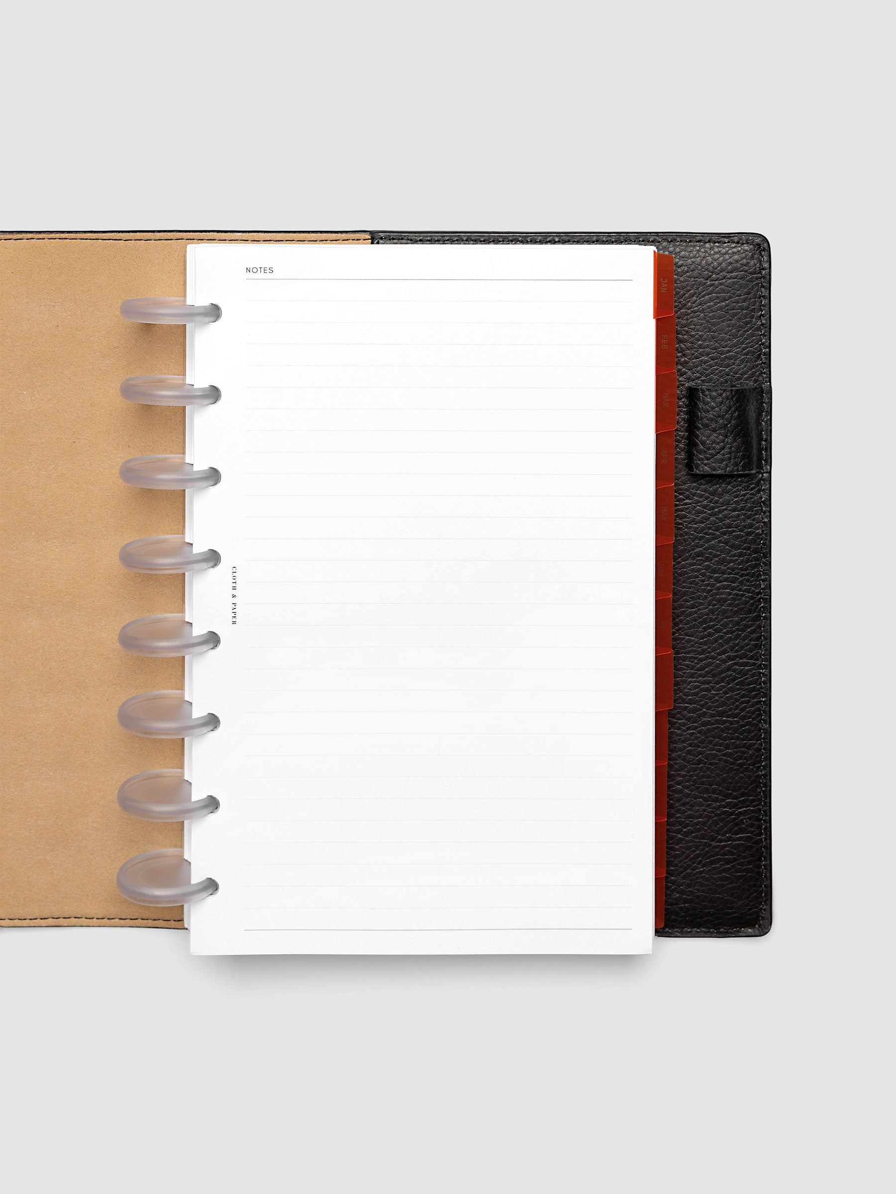 Half Letter 8-Disc Punch Ultra-Thin Monthly Dividers in deep orange shown tabbed inside a planner