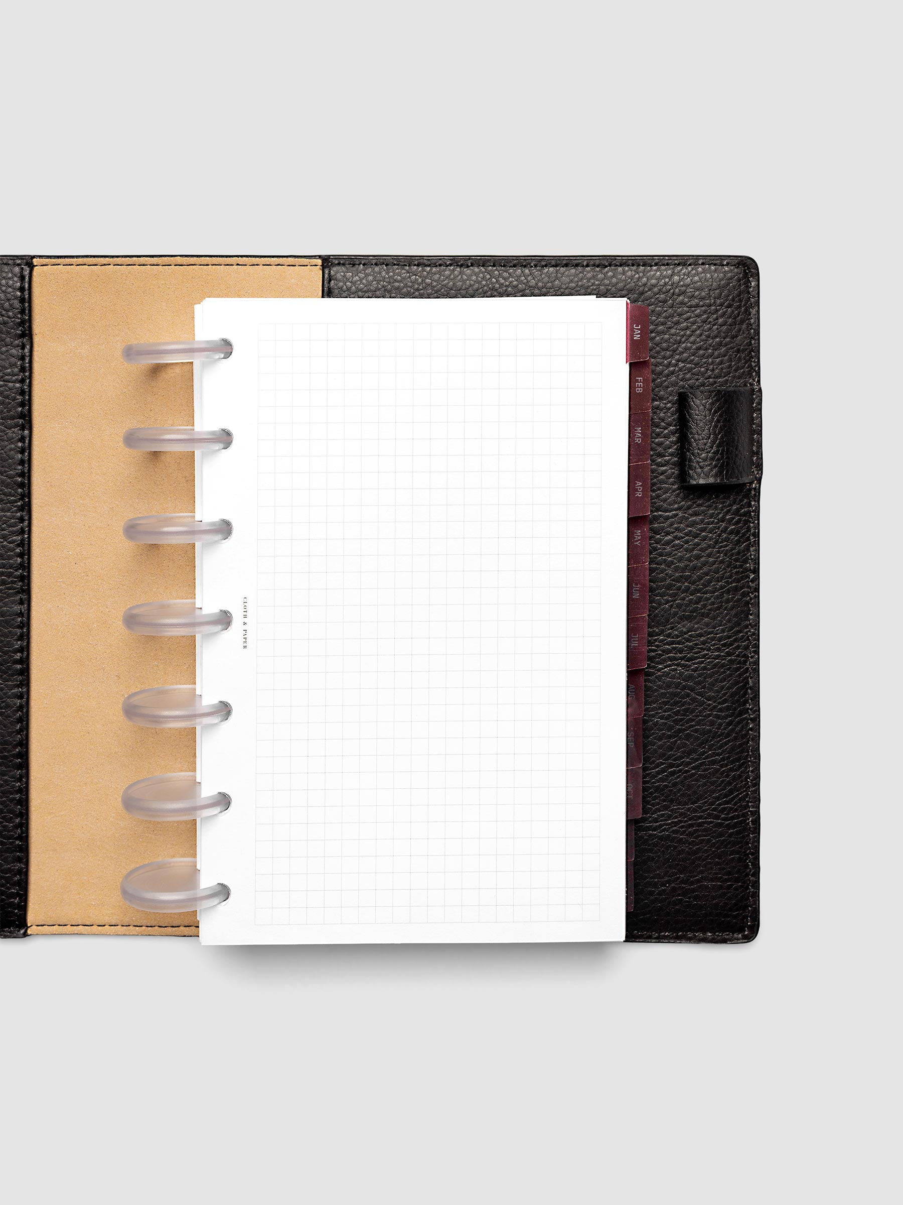 HP Mini 7-Disc Punch Ultra-Thin Monthly Dividers in deep red shown tabbed inside a planner
