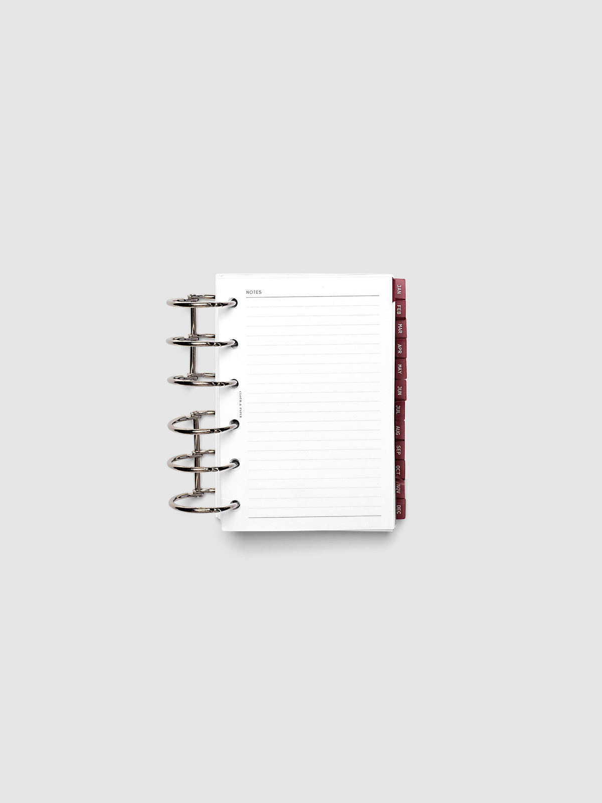 Pocket 6-Ring Punch Ultra-Thin Monthly Dividers in deep red shown tabbed inside a planner