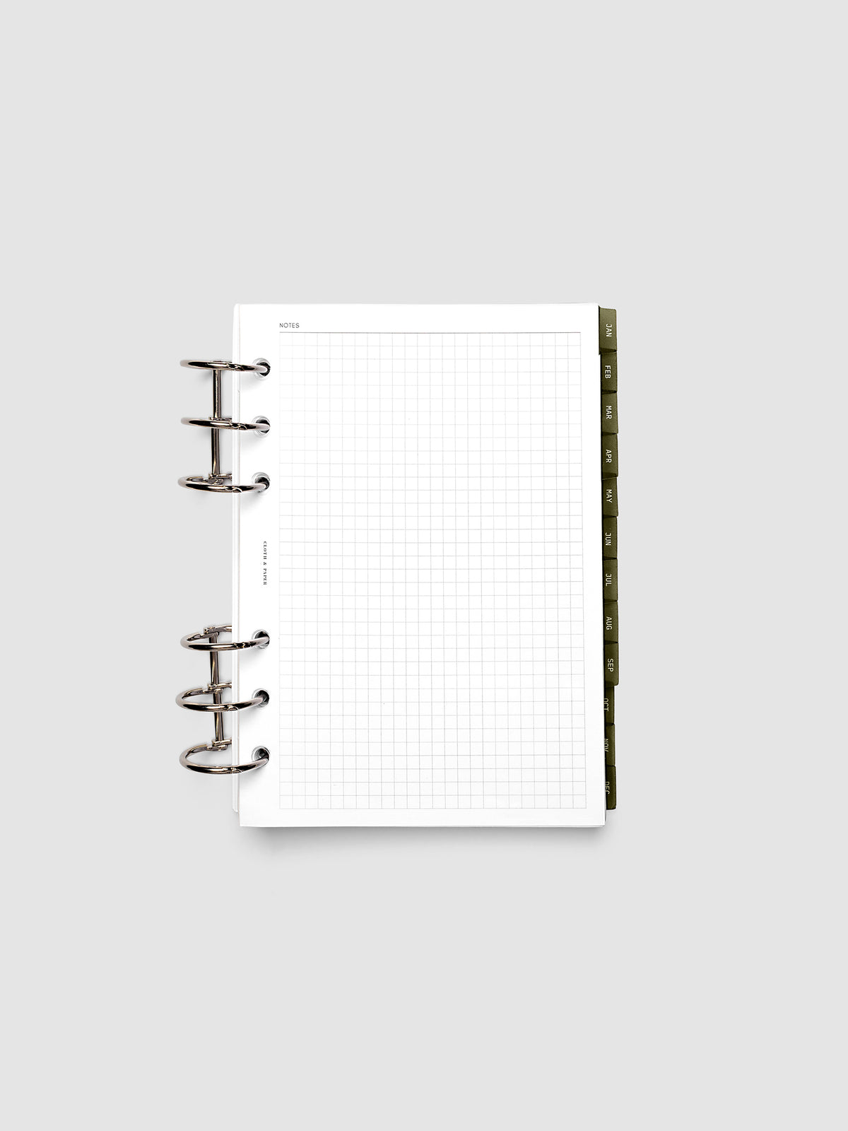 Personal Wide 6-Ring Punch Ultra-Thin Monthly Dividers in olive green shown tabbed inside a planner