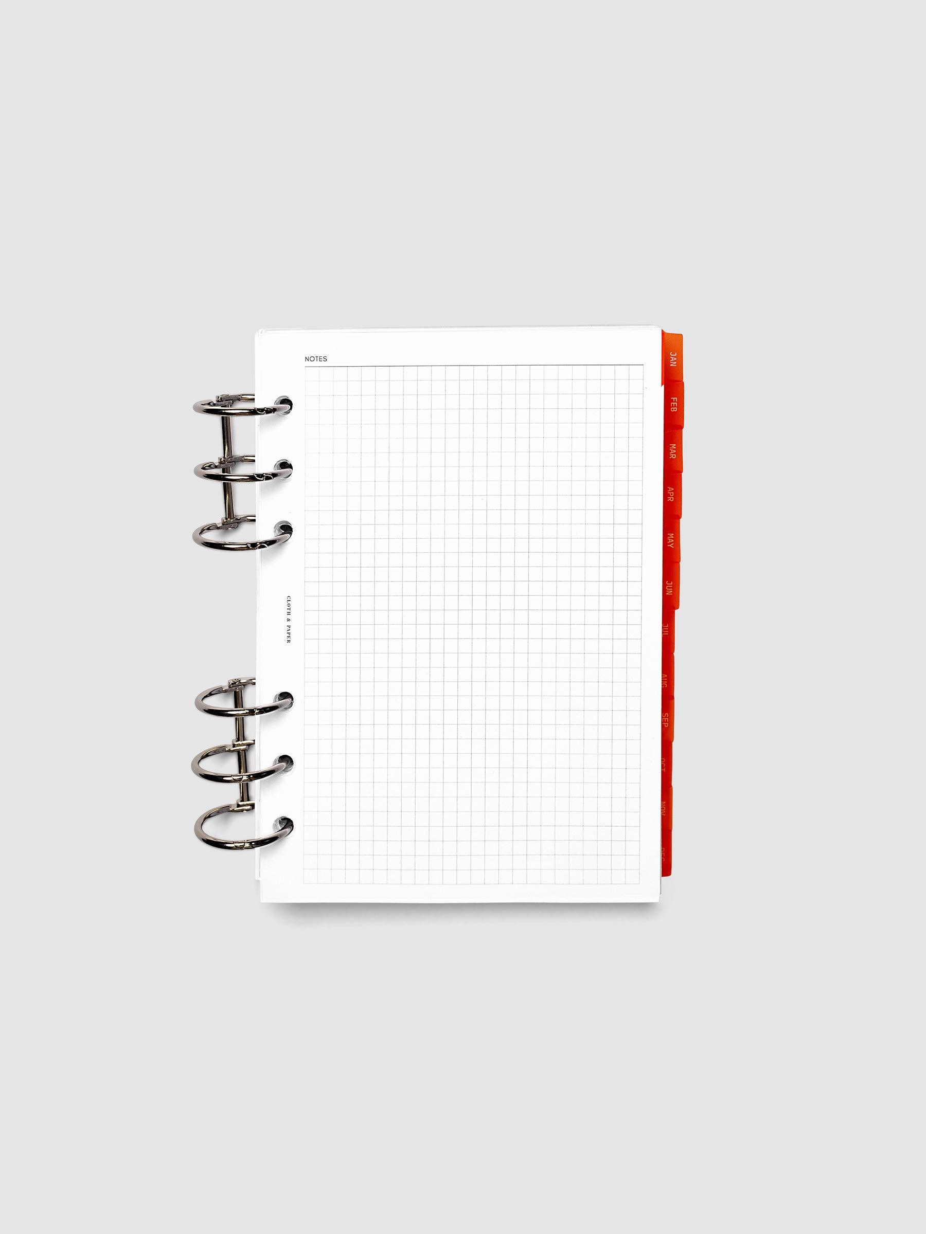 Personal Wide 6-Ring Punch Ultra-Thin Monthly Dividers in deep orange shown tabbed inside a planner