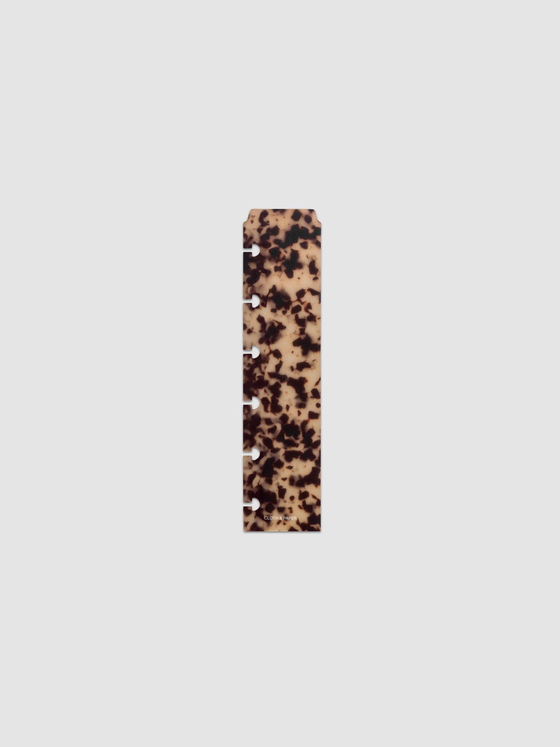 One narrow page marker in tortoiseshell pattern, shown in size CP Petite.