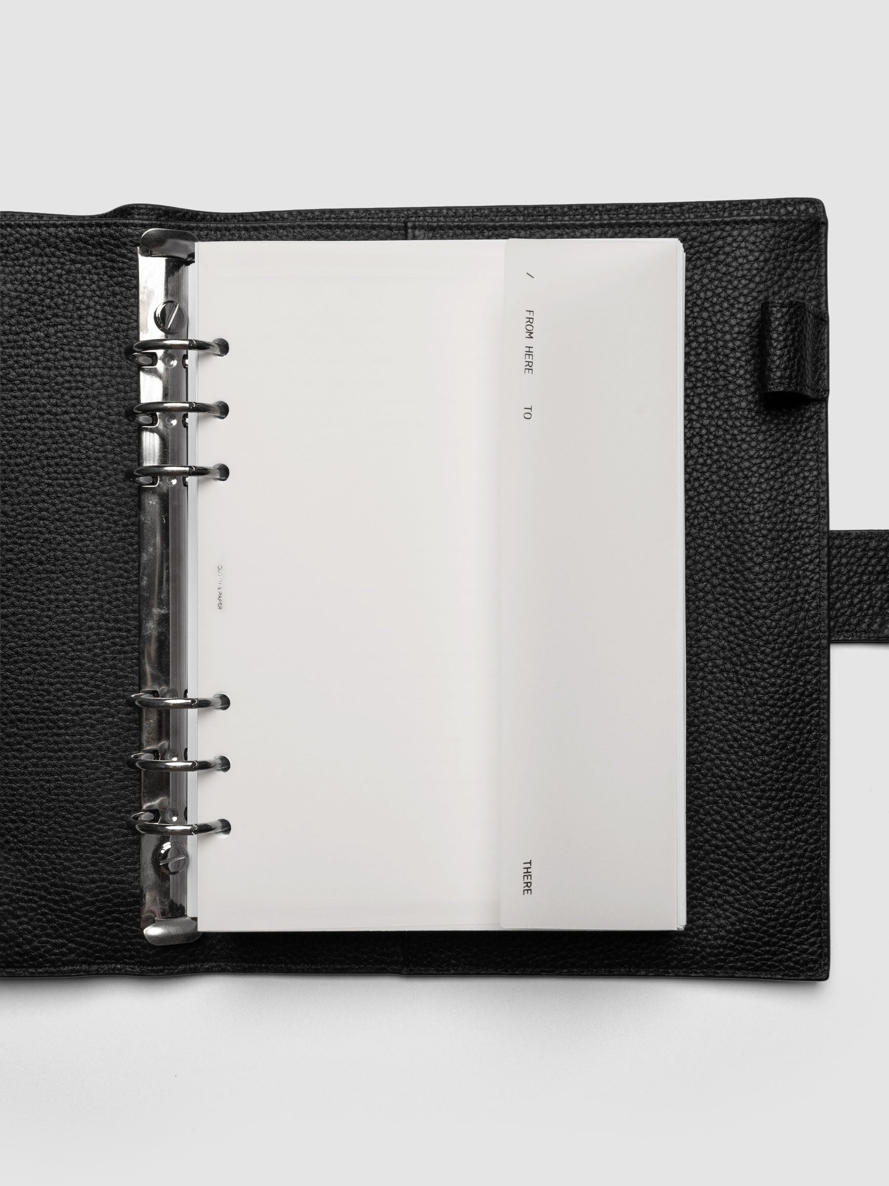 White Envelope Storage Holder shown inside a black, leather A5 agenda.