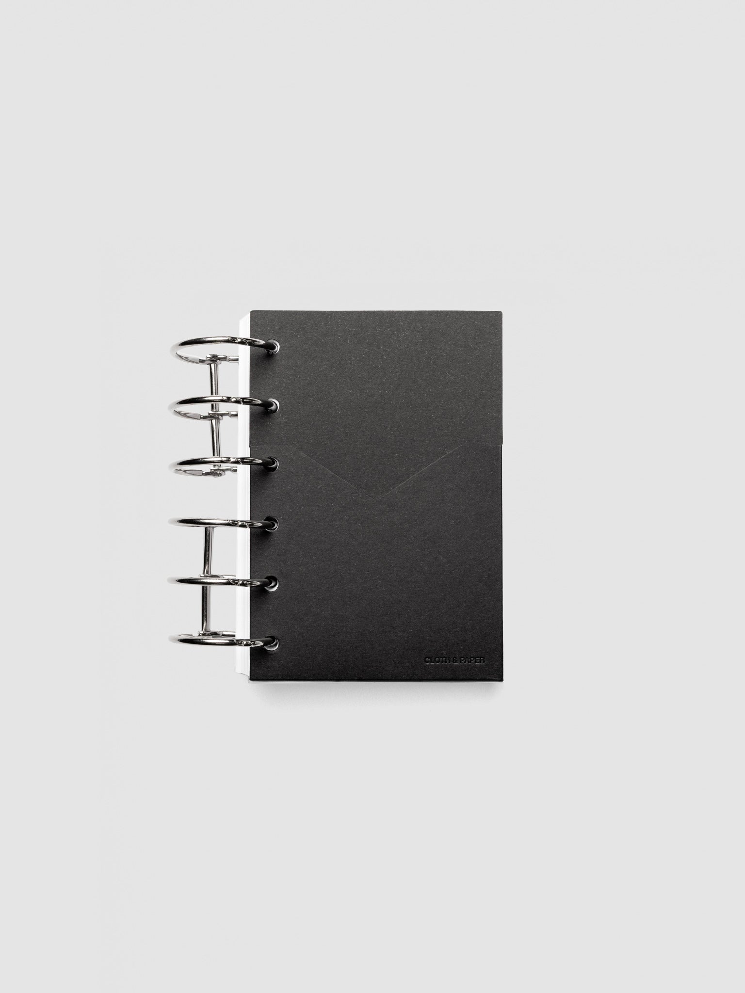 Black planner paper pocket folder shown inside a planner in size Pocket 6-Ring Punch