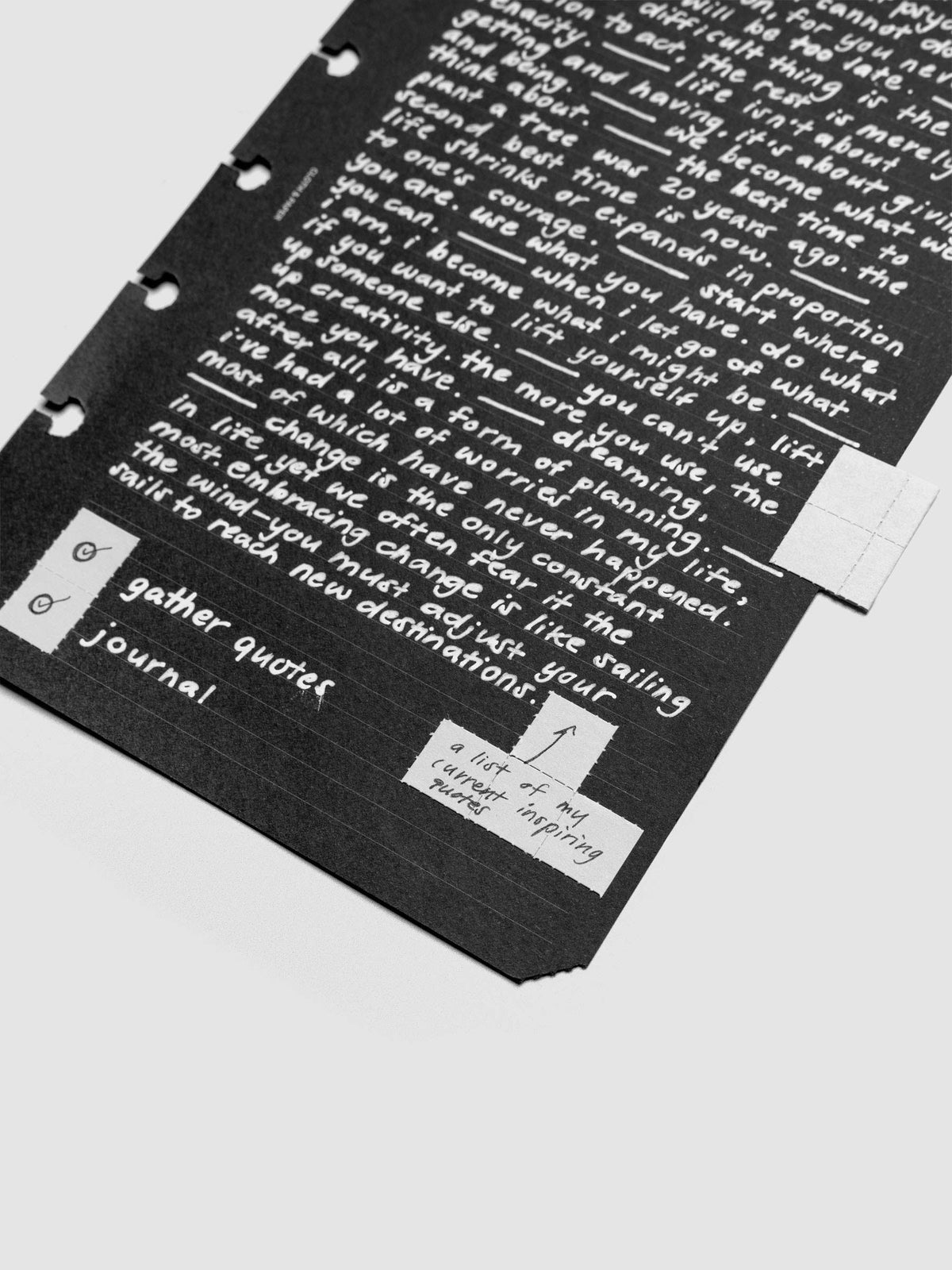 Grey tear-off stickers applied to a black planner insert with white writing