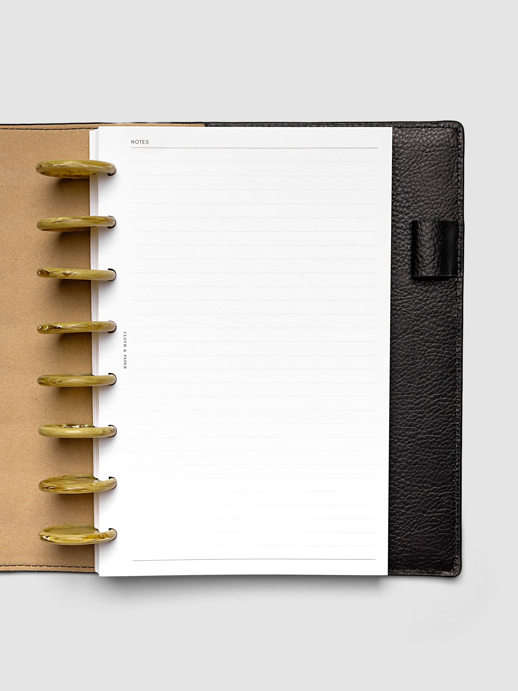 Carrara Verde 1.5" planner discs in use on an open discbound planner with pages secured on the discs