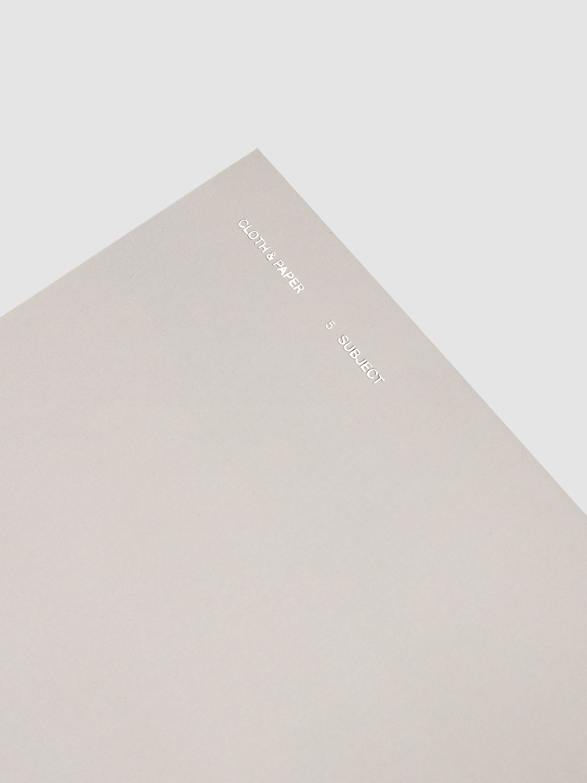 5 Subject Notebook A5 Punch top corner close up of light grey cover with silver foil branding