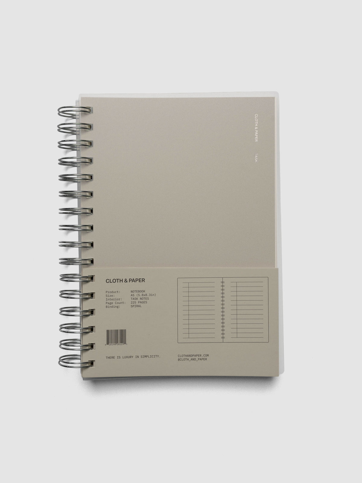 Spiral Notebook in size A5 and color Ristretto beige with Task interior pages shown closed with packaging.