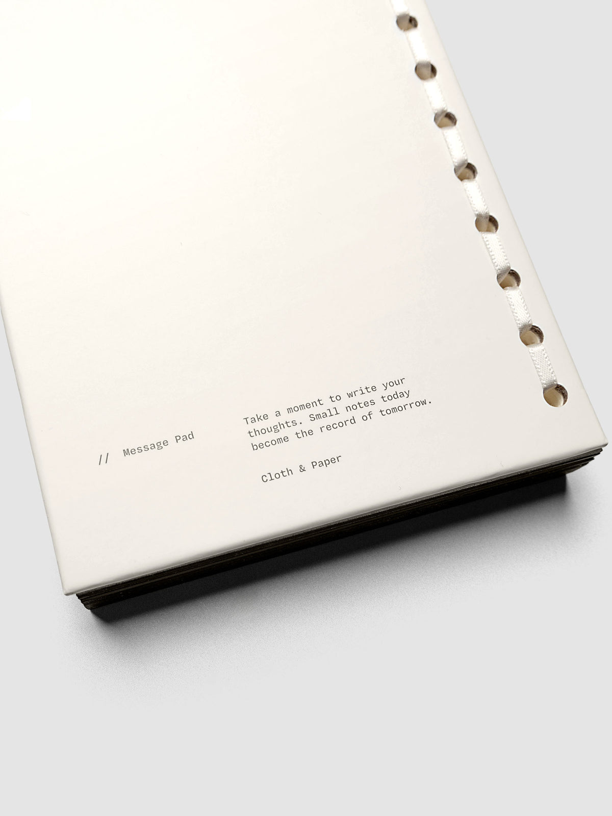 Back view of the message pad with text reading, "Take a moment to write your thoughts. Small notes today become the record of tomorrow."