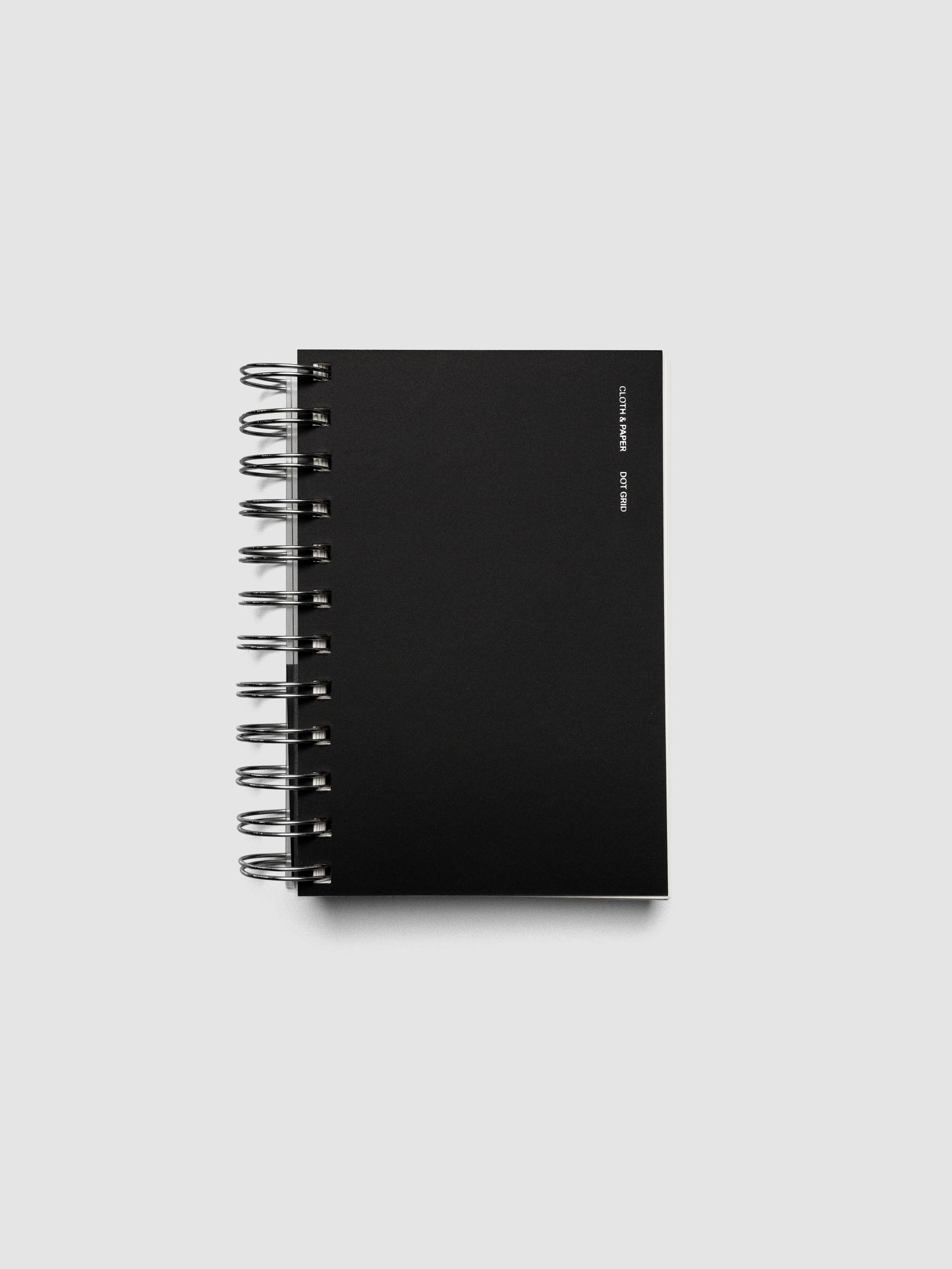 Spiral Notebook in size CP Petite and color Avant Garde with Dot Grid interior pages shown closed displaying the soft touch dashboard.