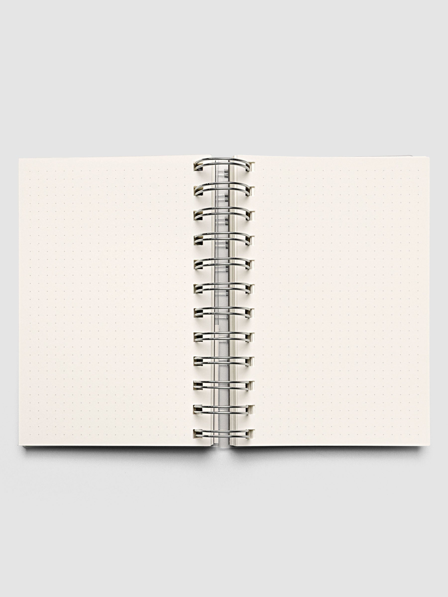 Spiral Notebook in size CP Petite with Dot Grid interior shown open displaying both left and right pages.