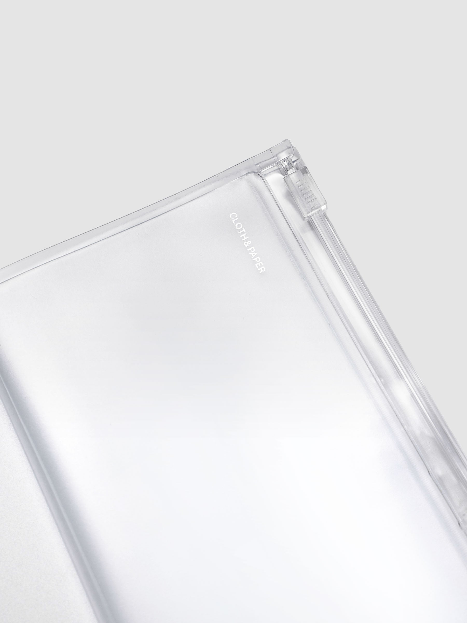 Close-up of the Pocket Plus travel notebook storage holder zipper and clear frosted plastic construction