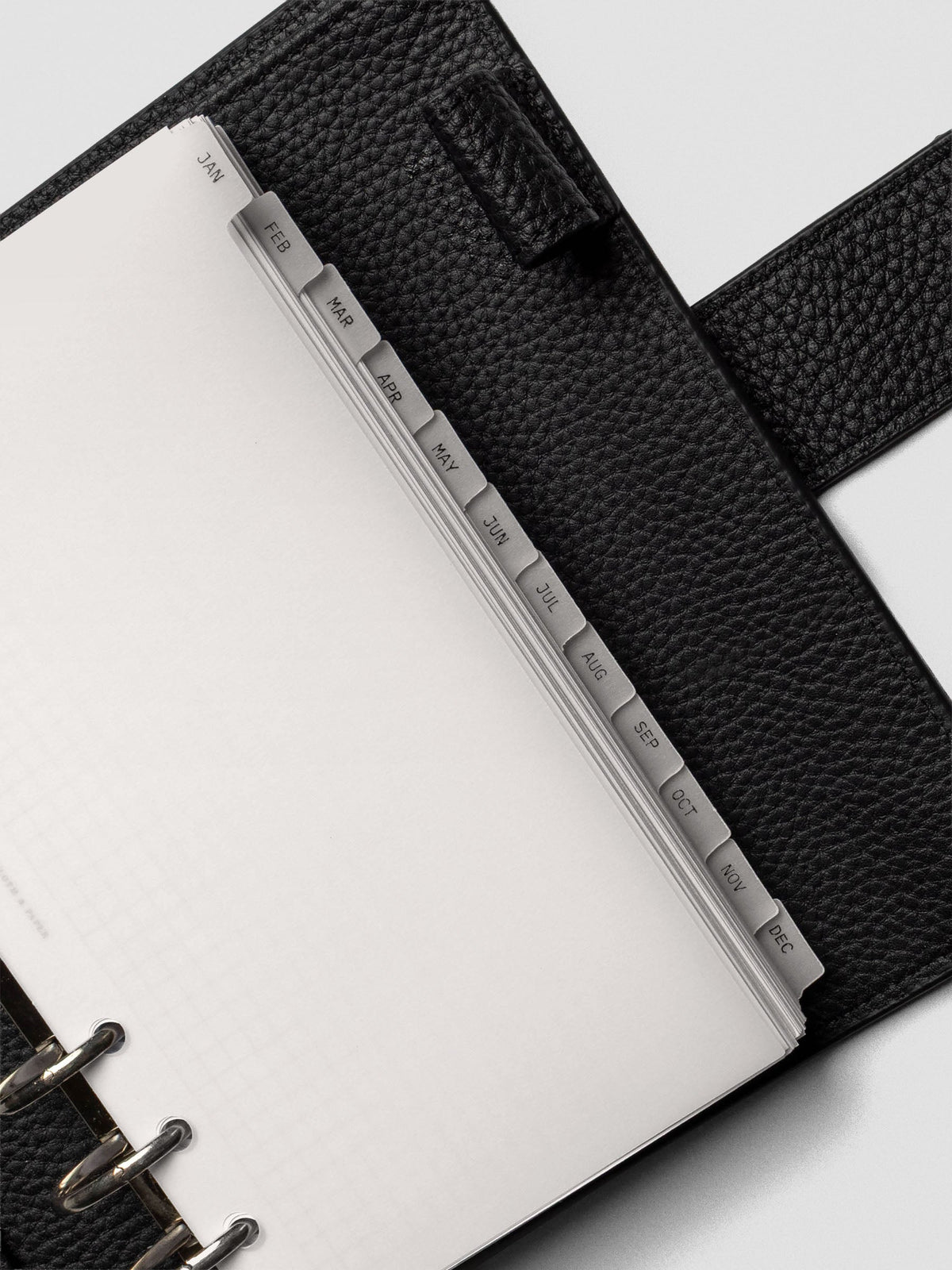 Close up of personal vellum dividers shown at an angle bound with rings.