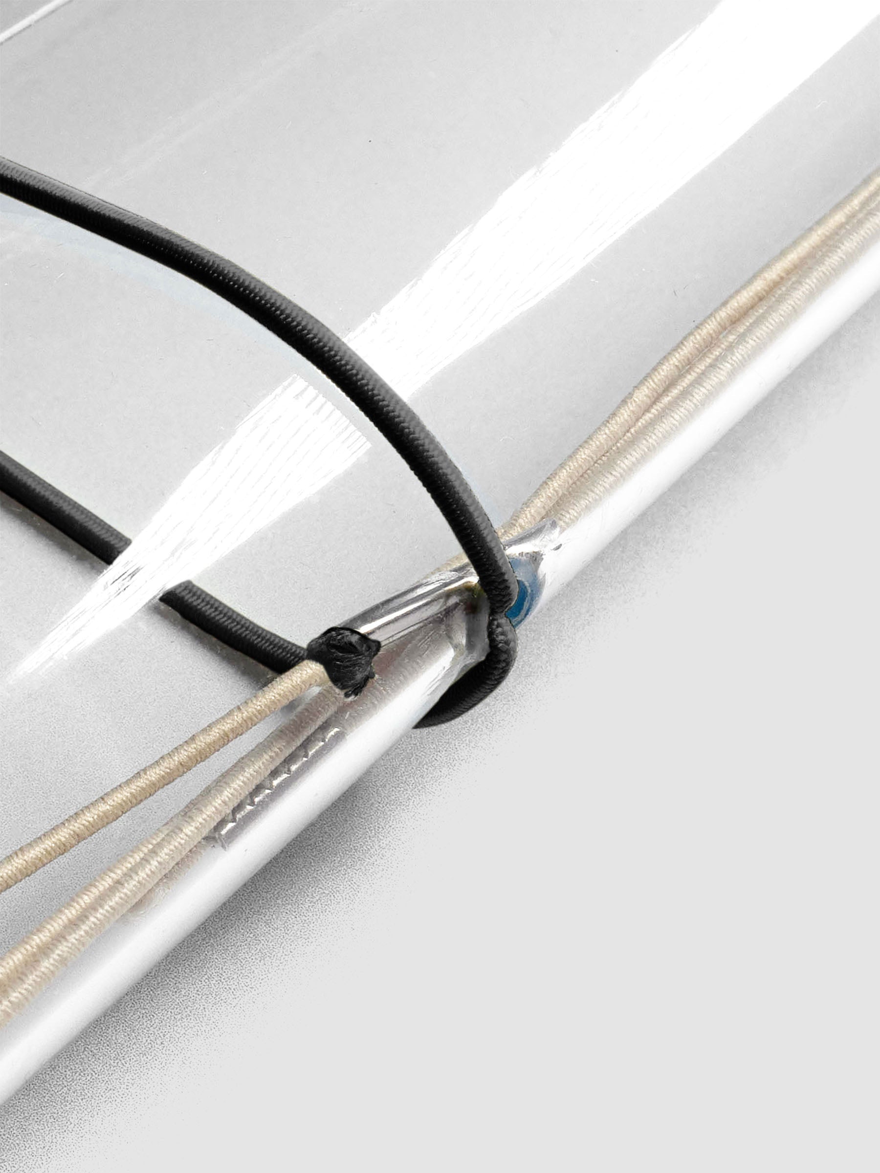 Black elastic exterior band looped through clear vinyl travel cover spine.