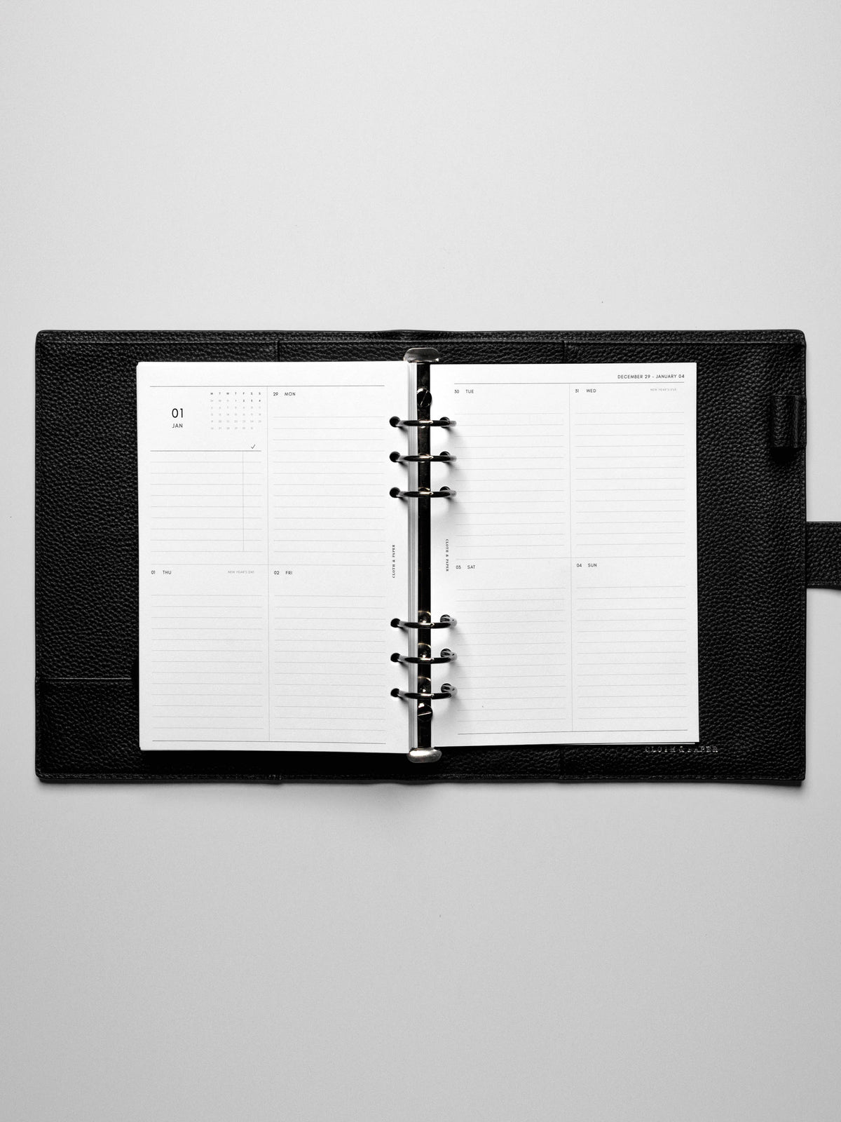 Image shows the Monday Start 2026 Dated Vertical Weekly Planner Inserts used in a black A5 leather binder.