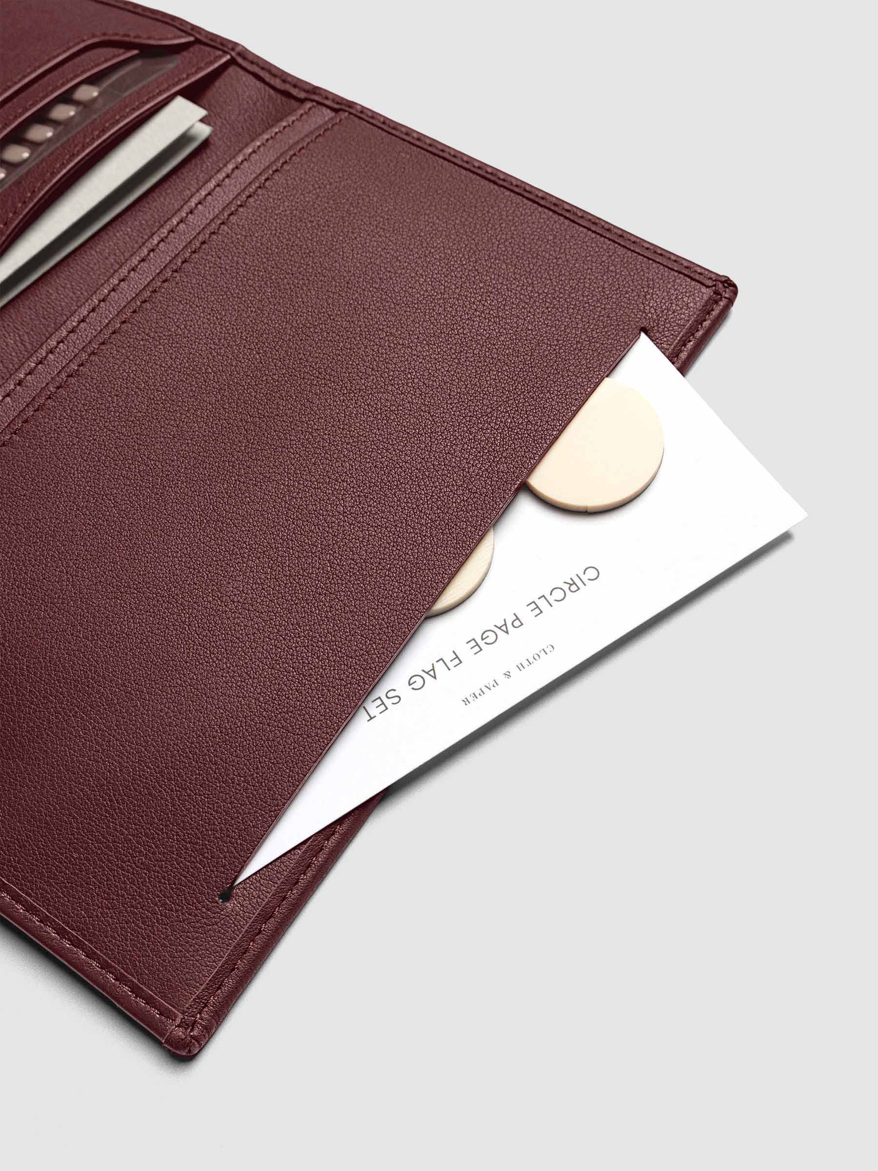 Close-up of page flags tucked into the slit pocket of Nomada Wallet in Madrid