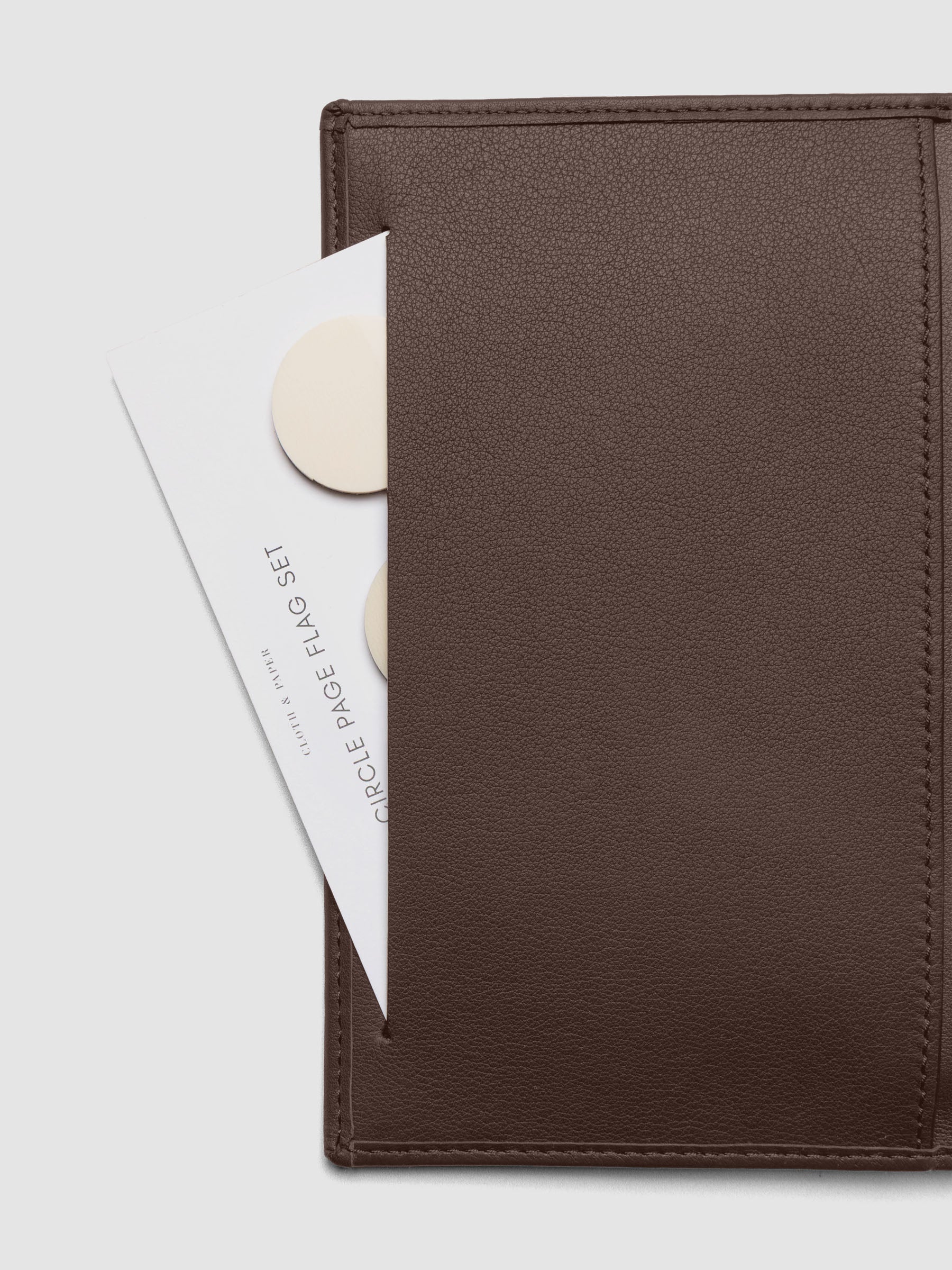Close-up of Nomada Wallet slit pocket in Cordoba with page flags inside