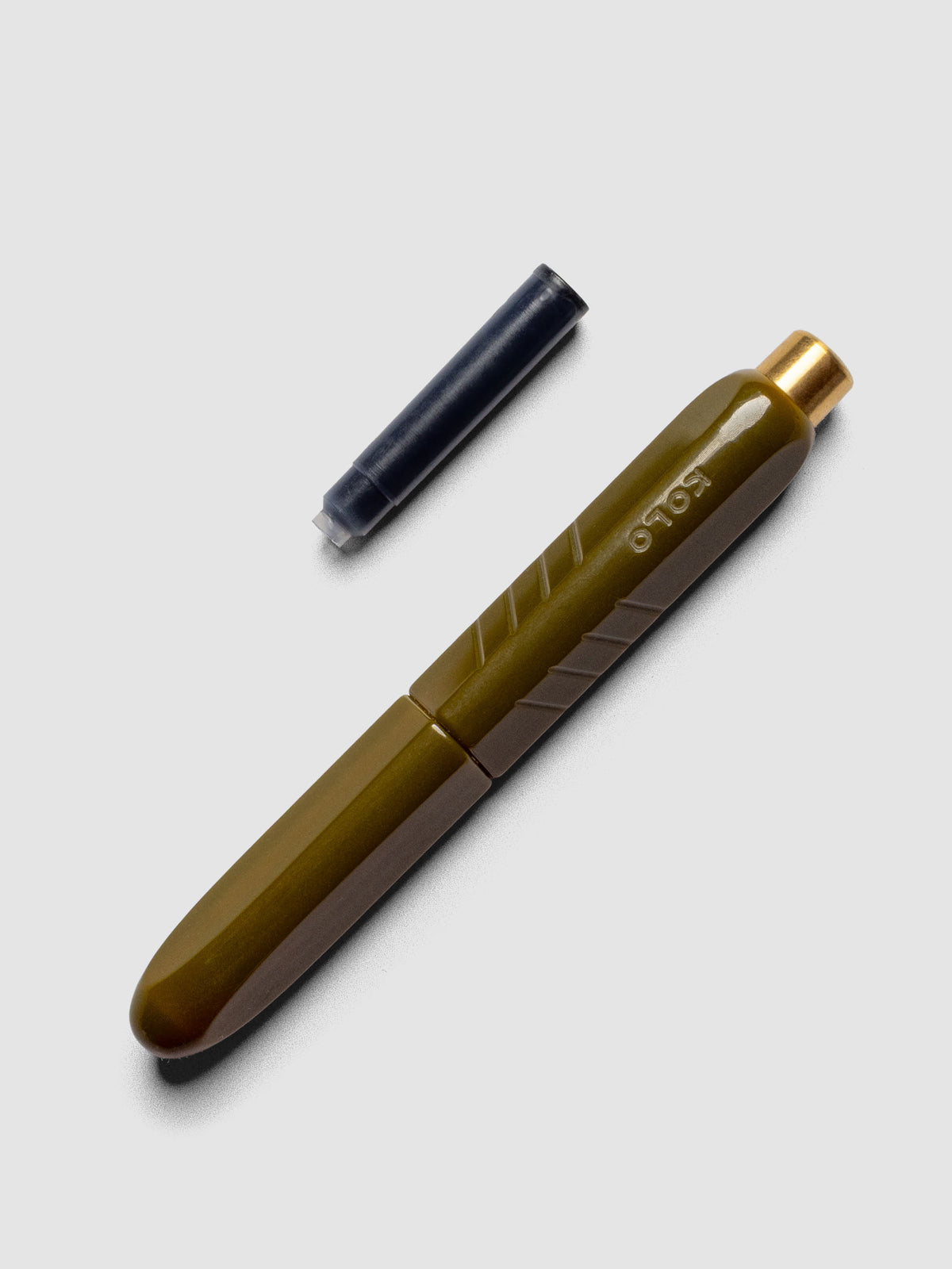 Kolo Tino Fountain Pen in the color Acrylic Wasabi, shown cap on with ink cartridge resting beside pen.