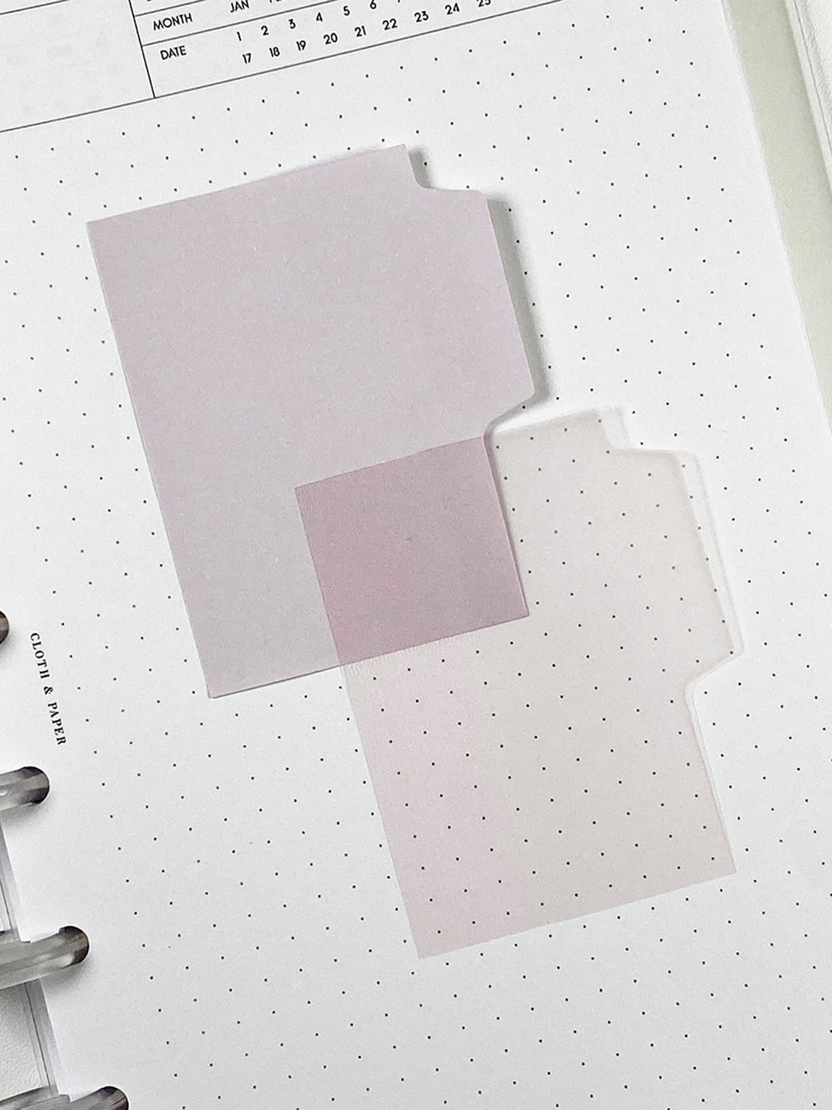 Blank Tab Sticky Note Set, Cotton, Cloth and Paper. One matte and one transparent sticky note from the set placed on a task insert. The transparent sticky note is layered over the bottom right corner of the matte sticky note.
