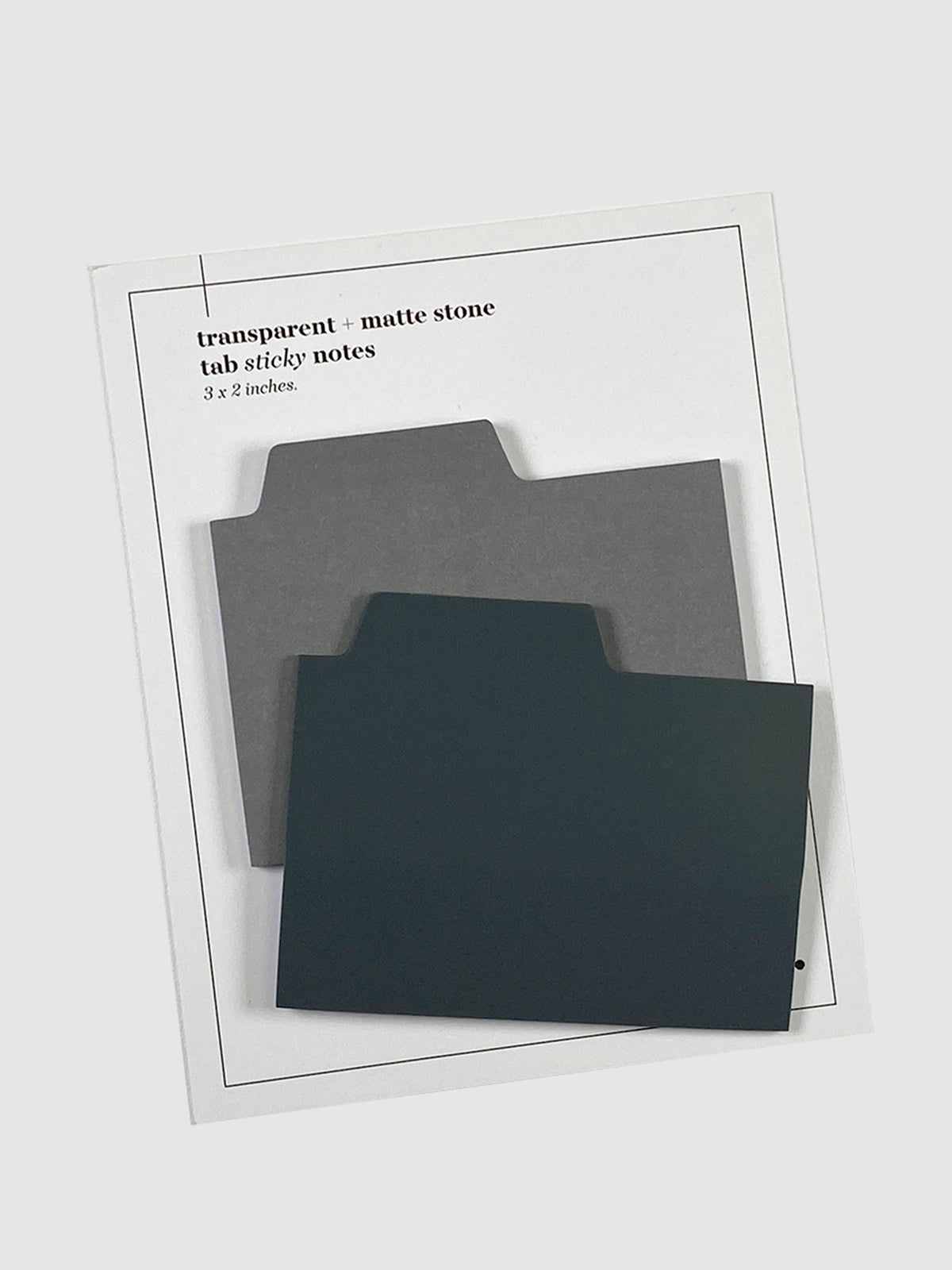 Blank Tab Sticky Note Set, Stone, Cloth and Paper. Sticky note set displayed against a neutral background. The matte sticky note pad is attached to the sticky note backing, while the transparent sticky note pad is layered on top of it, turned slightly to the right.