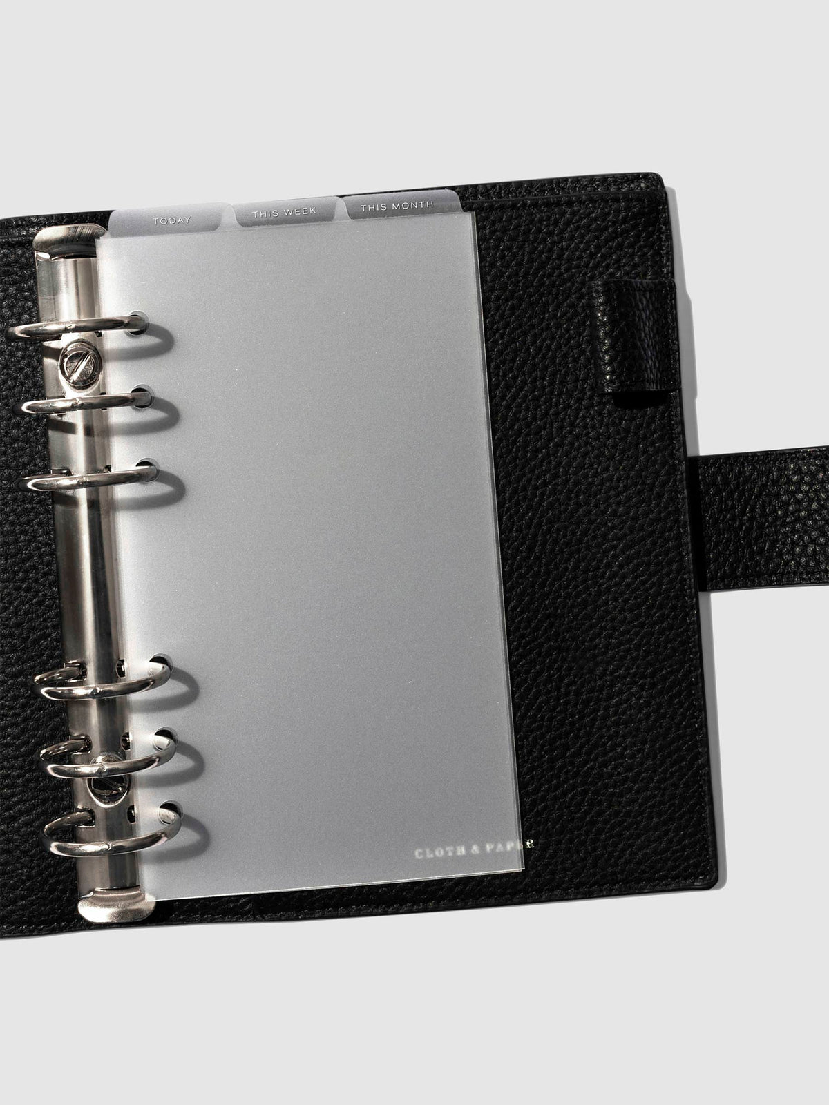 Personal White Foil Cadence Tab Dividers displayed in a black leather planner.