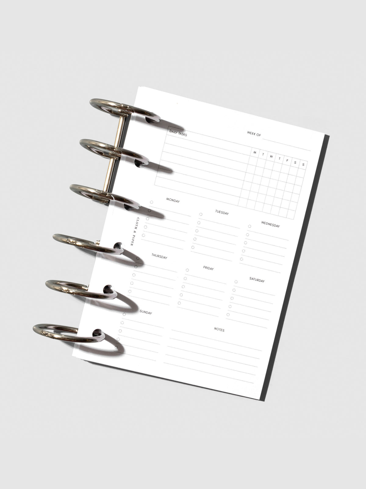 Pocket sized insert placed inside a pair of silver planner rings.
