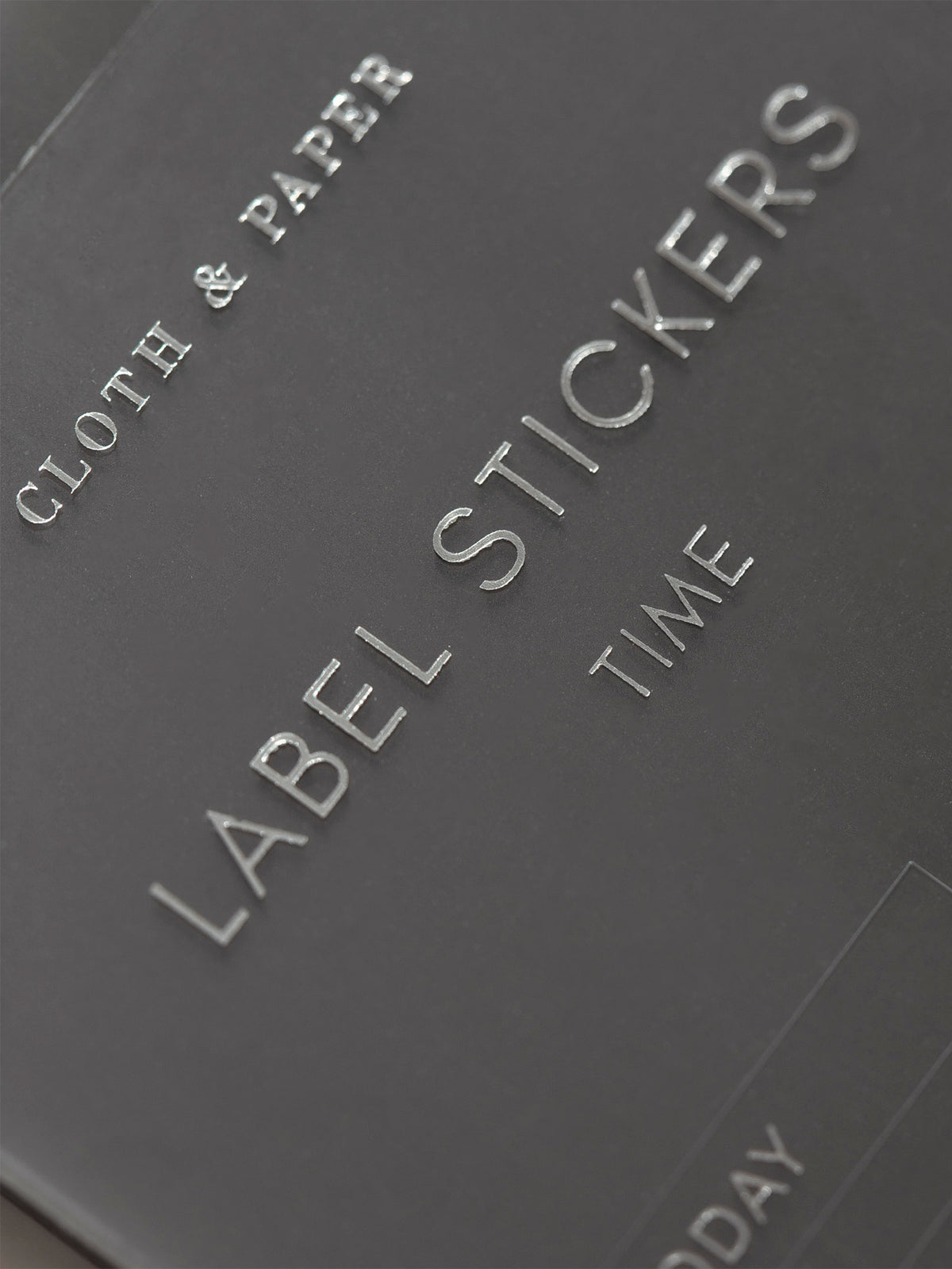 Zoomed in photo of the Clear Label Stickers spotlighting the title of the sticker sheet that says Label Stickers Time